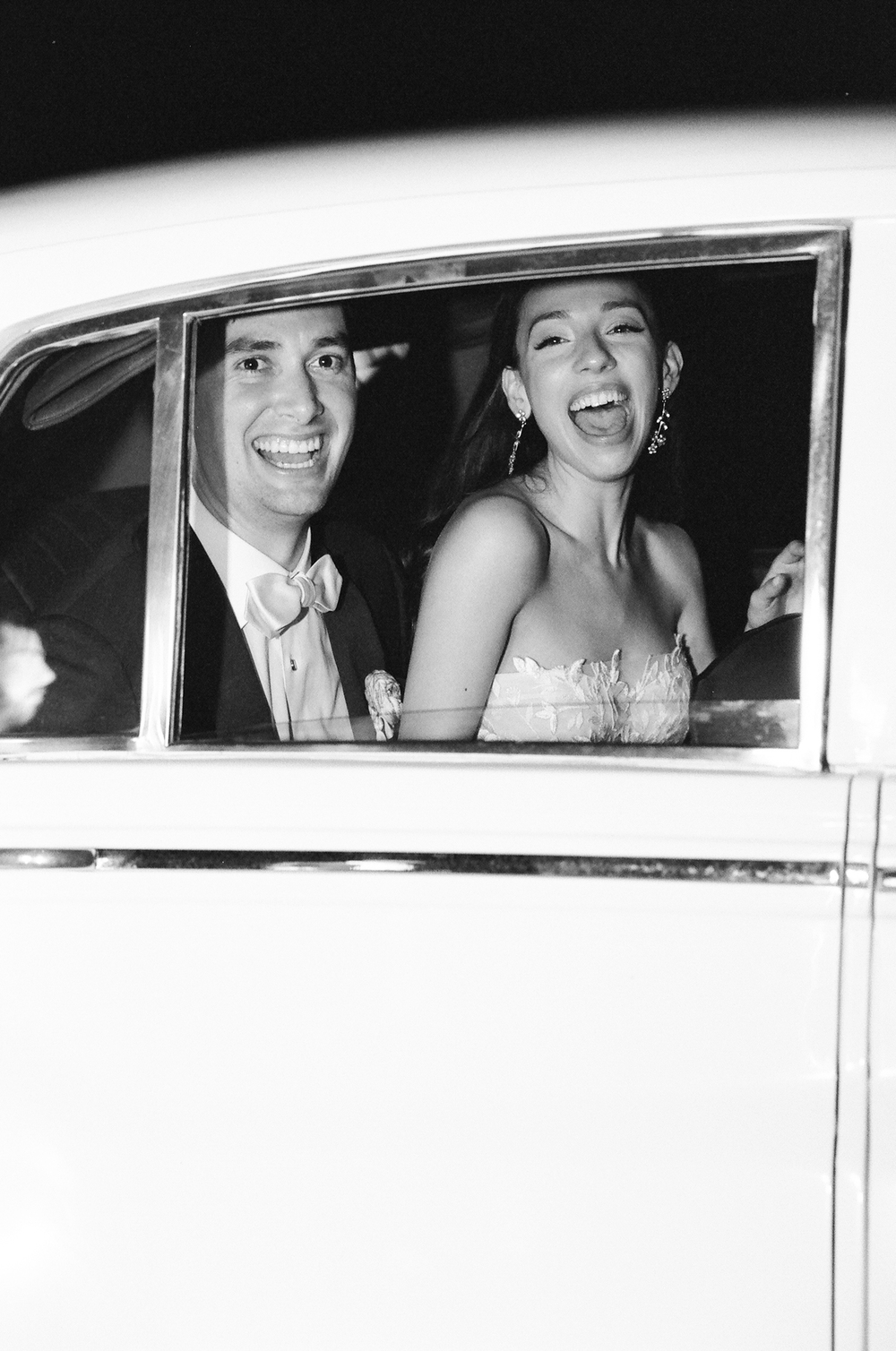 wedding couple leaves reception in vintage car