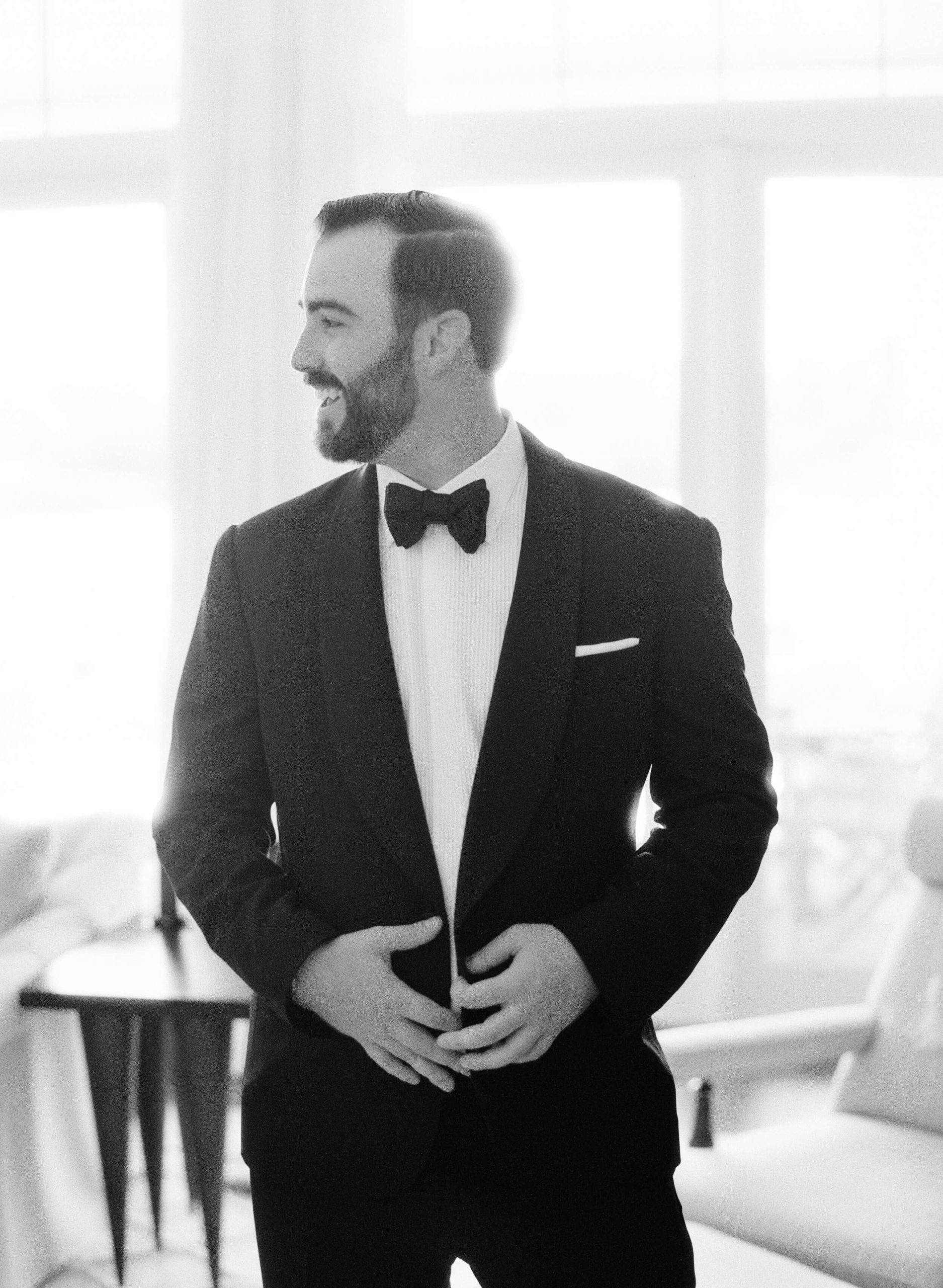 black and white portrait of groom in tuxedo before at-home wedding in Tampa