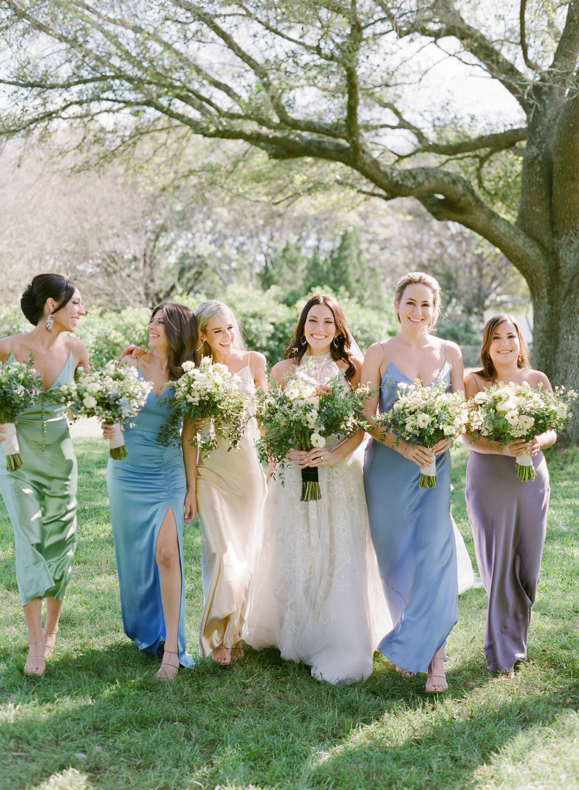 bridesmaids and bride carry wildflower bouquets