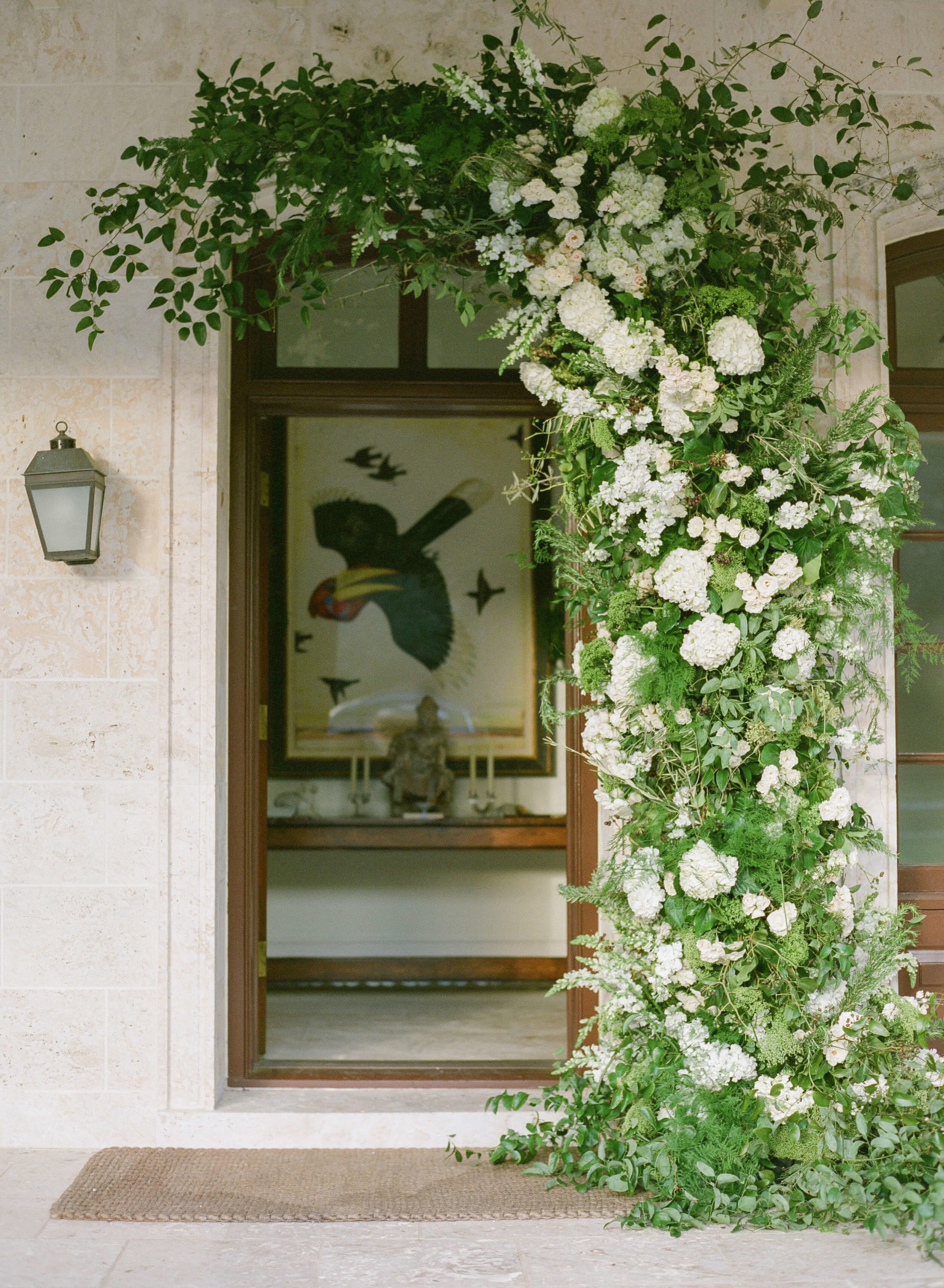 white floral arch over doorway to home
