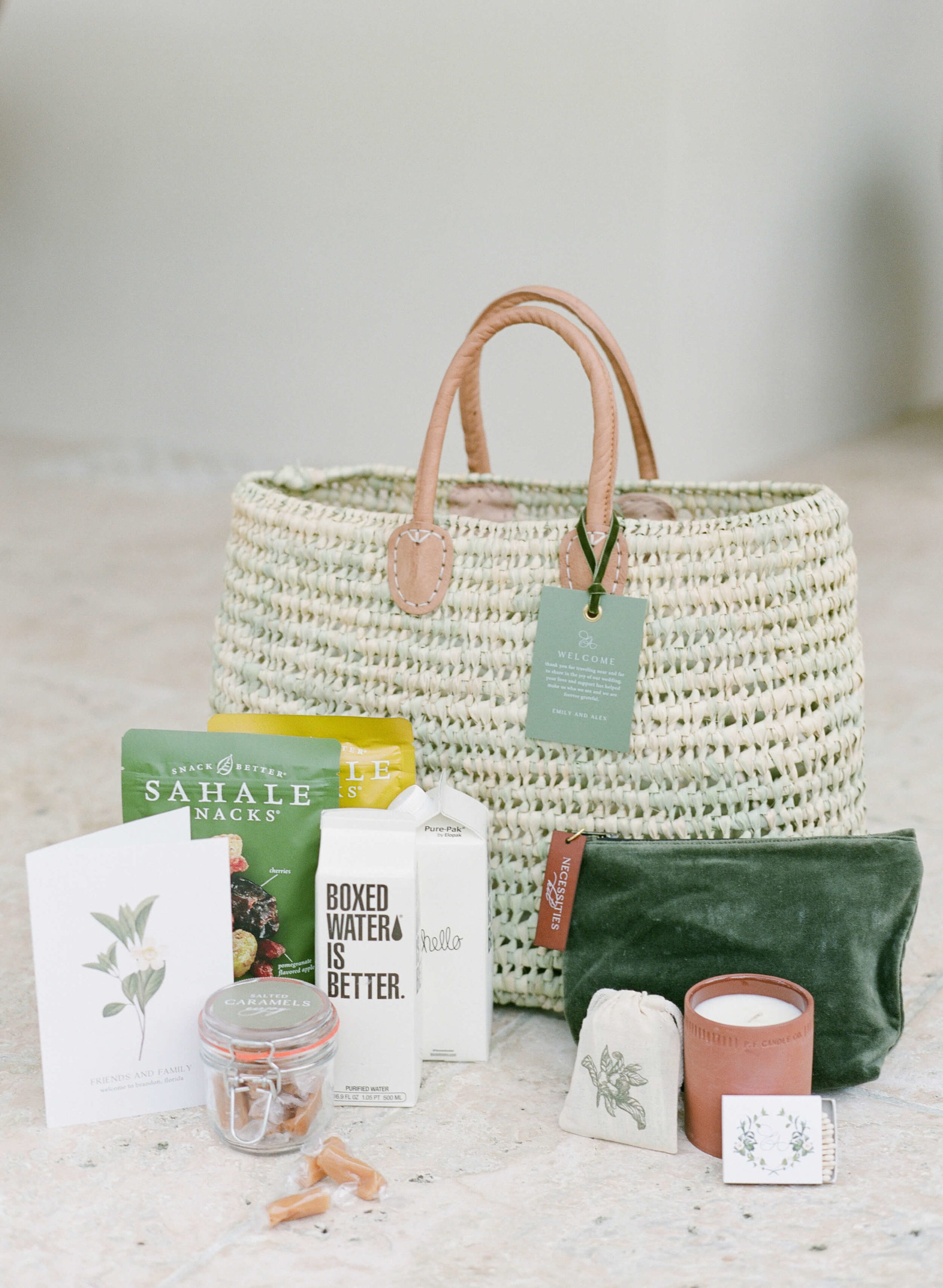 welcome bag with snacks, candle and water for wedding guests