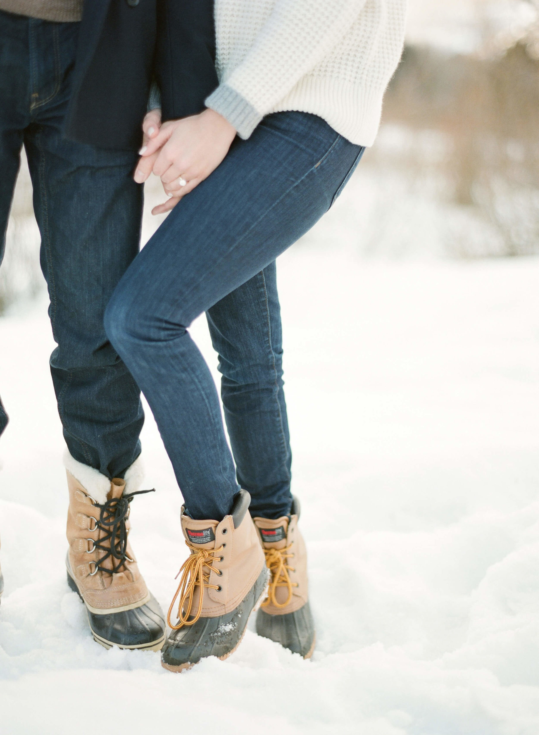 couple holding hands in winter photoshoot