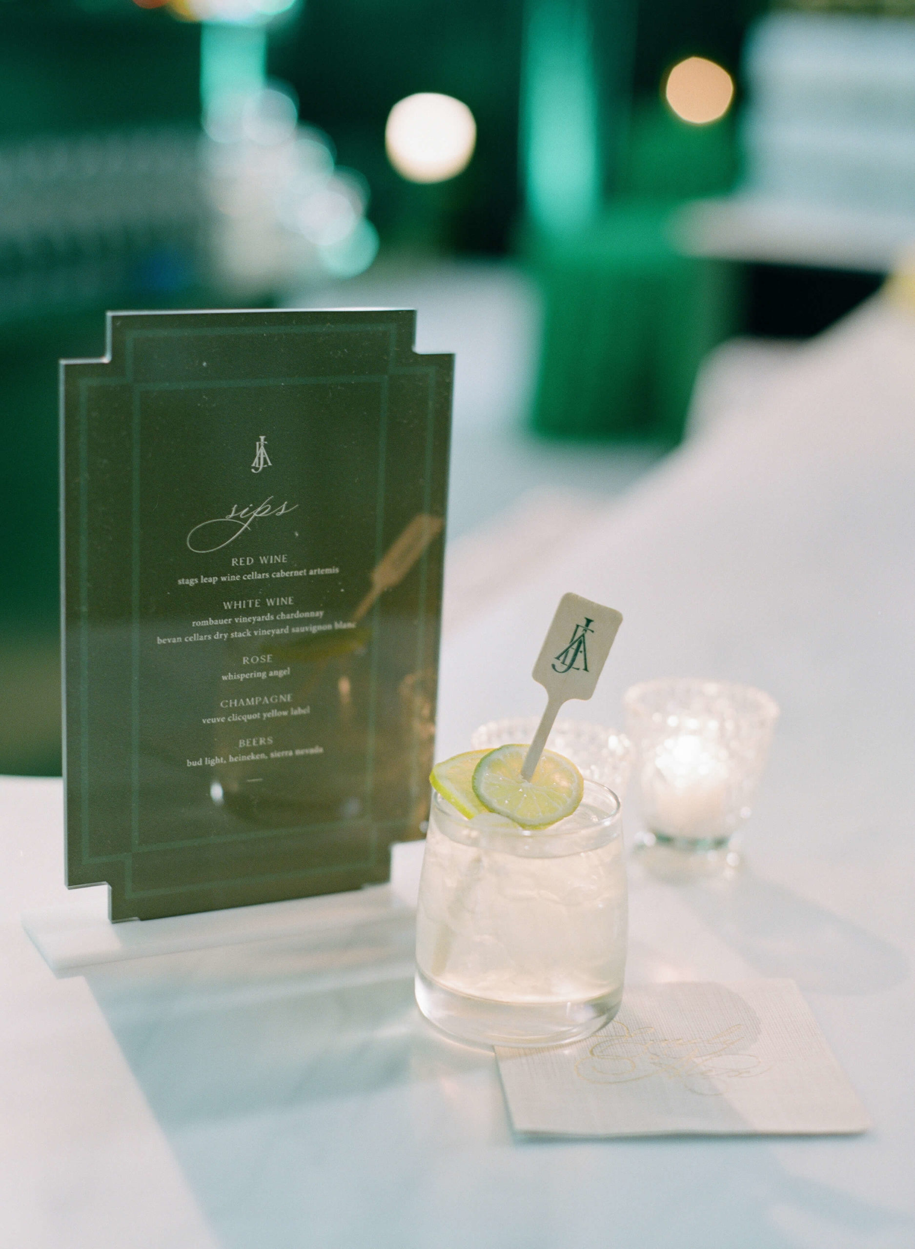 a drink menu beside a custom cocktail