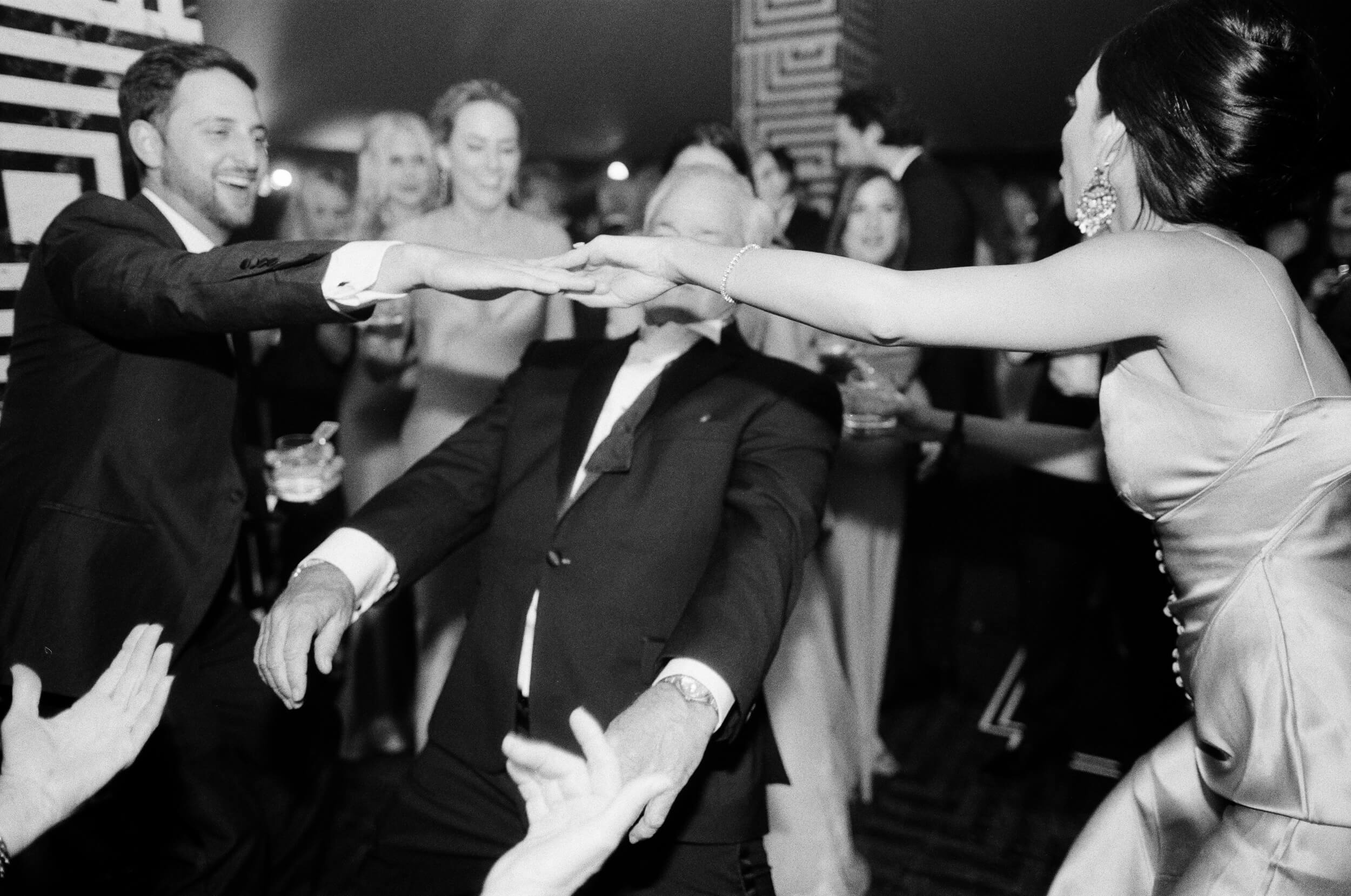 guests do the limbo at dance party reception