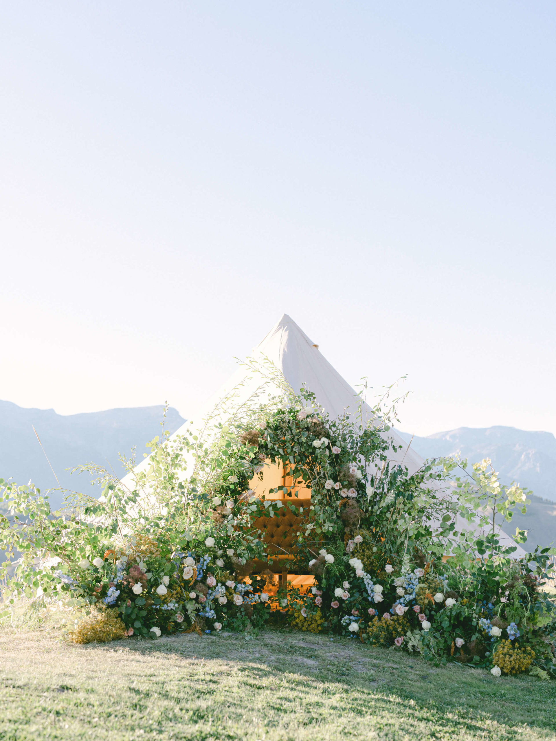 canvas tent with floral arch