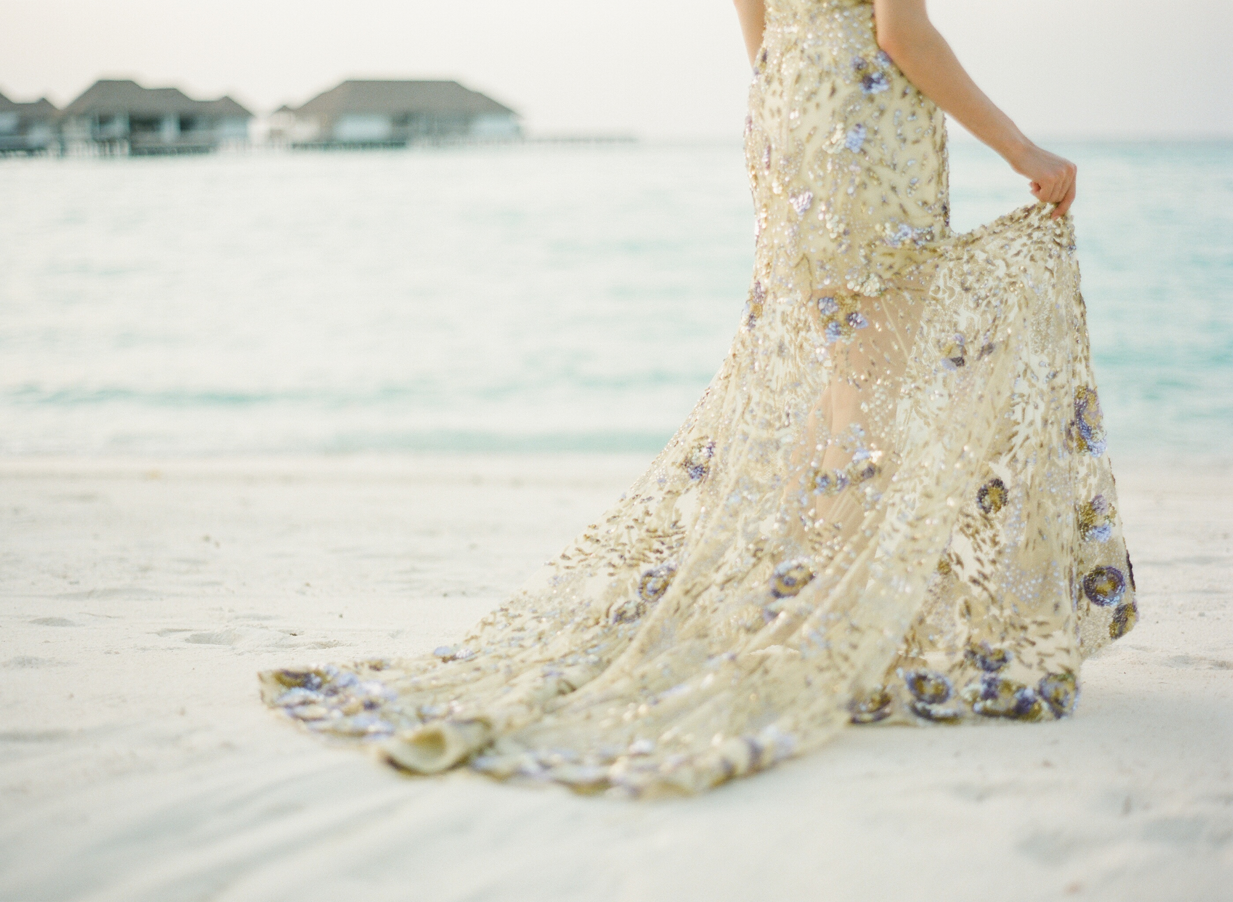 bride in beaded gown on Maldives beach