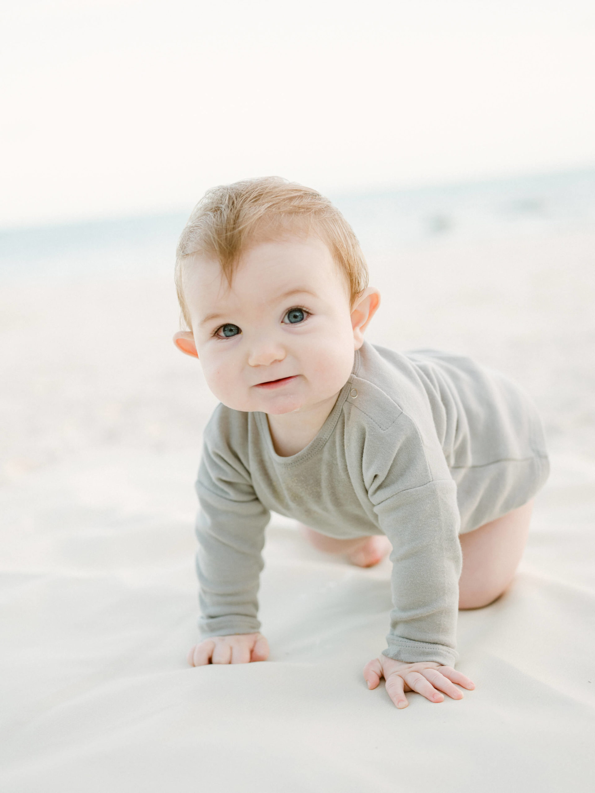 little boy crawling on the beach
