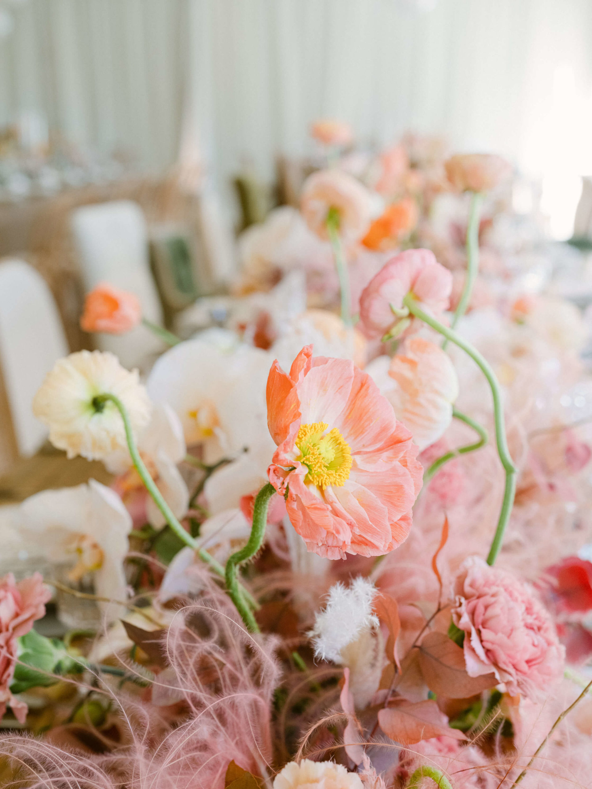 pink and terra cotta flowers on wedding reception table