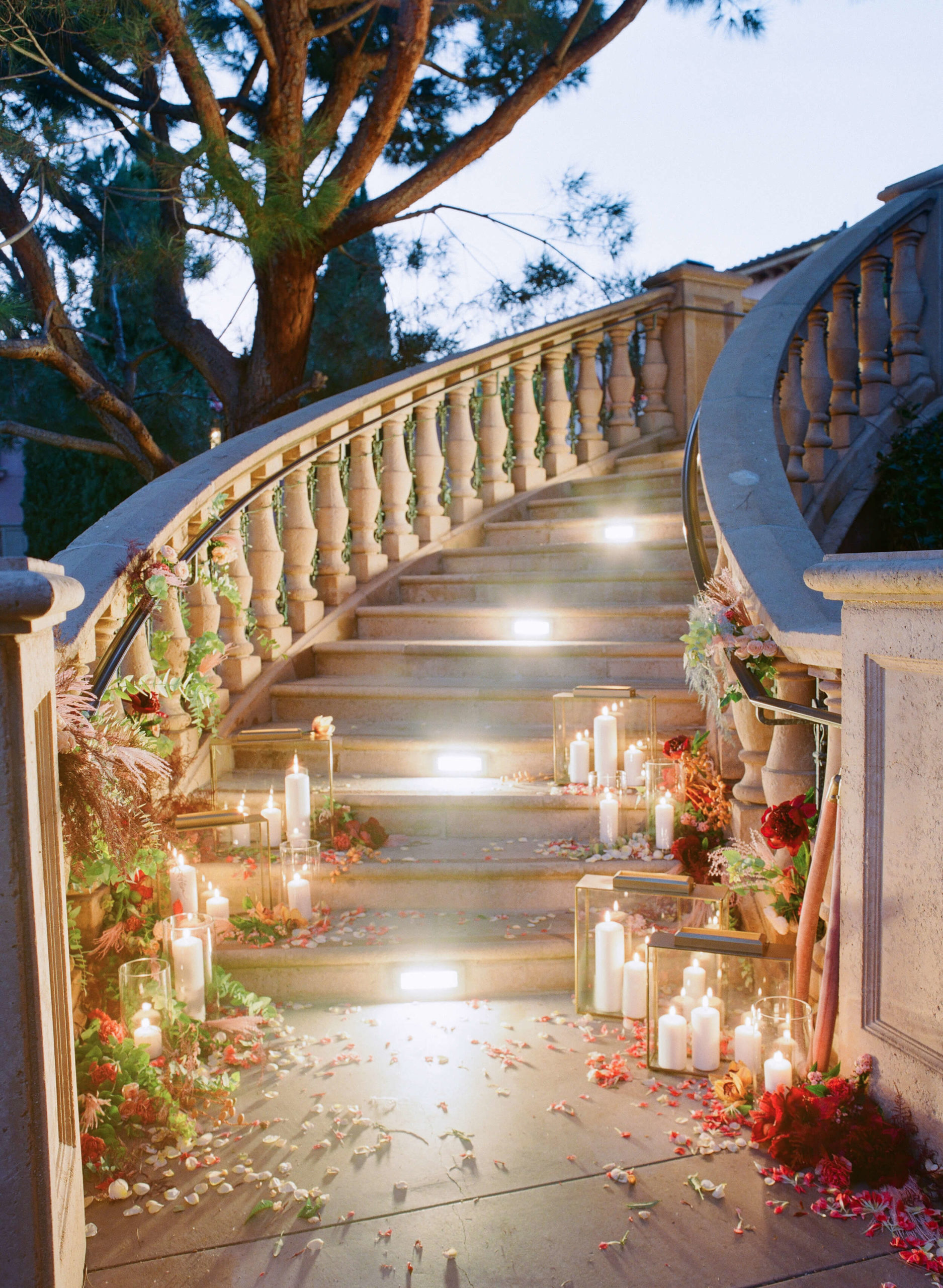 candlelit staircase with colorful fall flowers