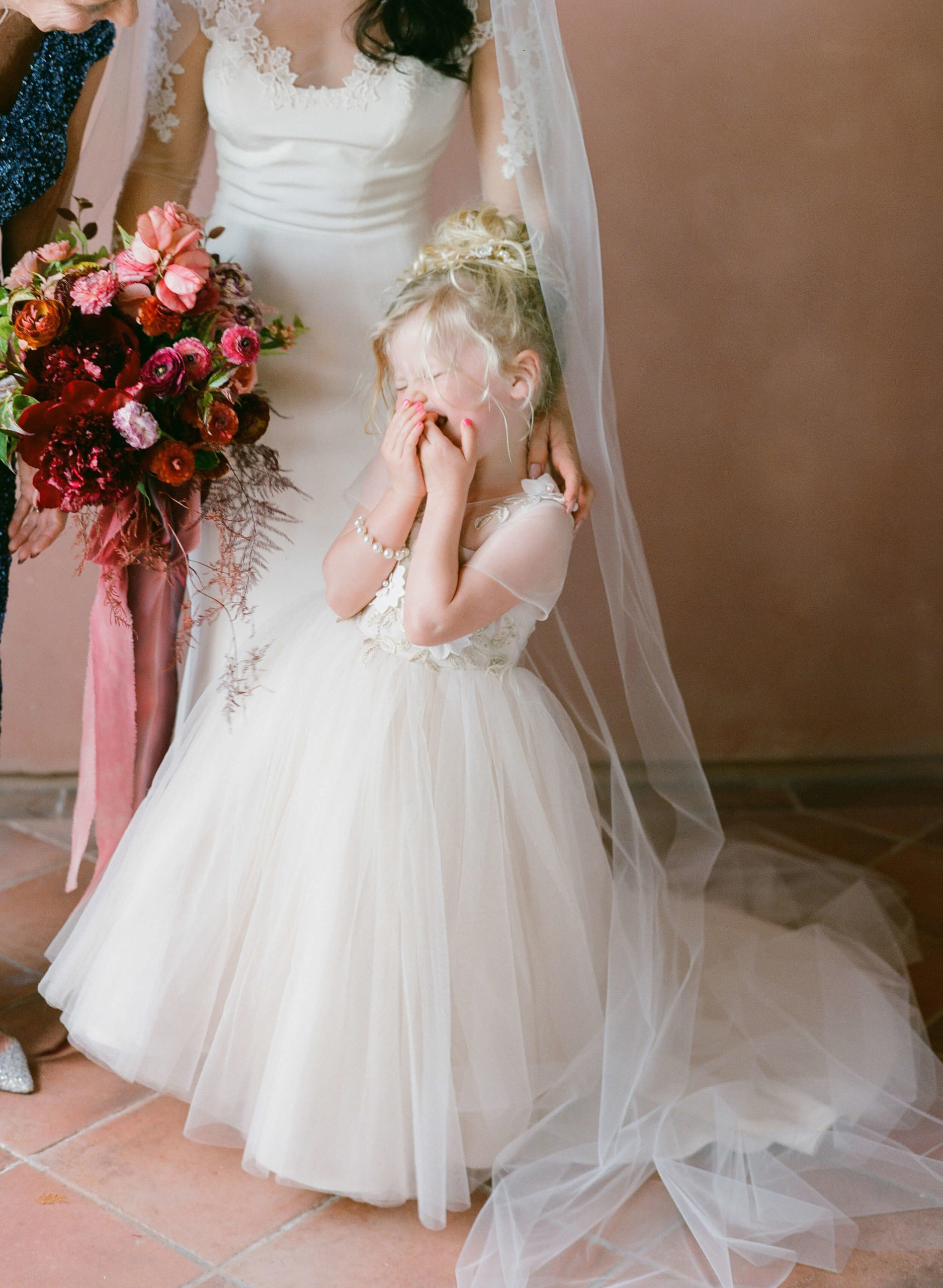 flower girl laughing with bride