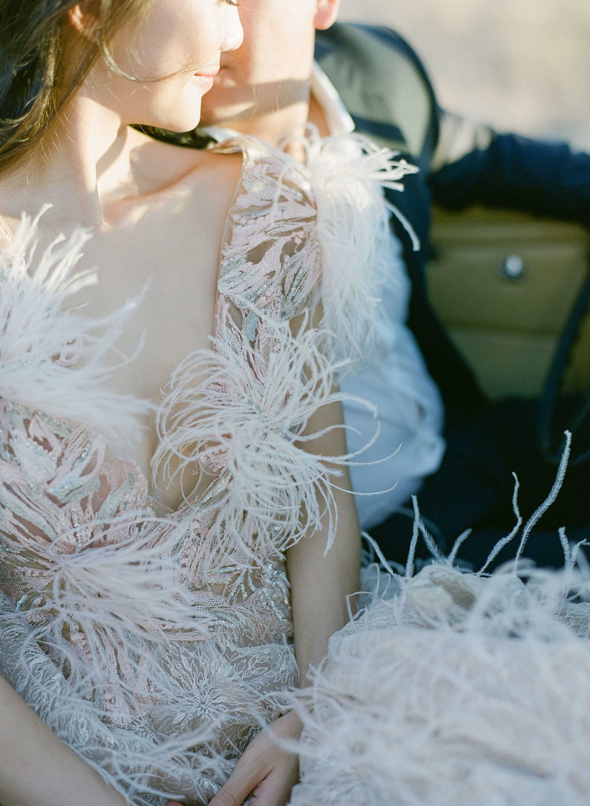 feathered and embroidered pale blush gown worn at engagement shoot