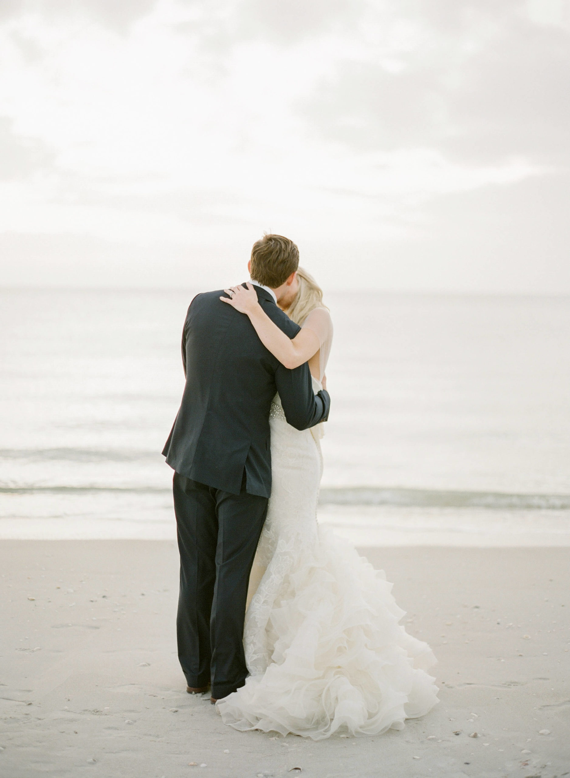 hiring a bridal stylist creates great wedding photos of beach wedding