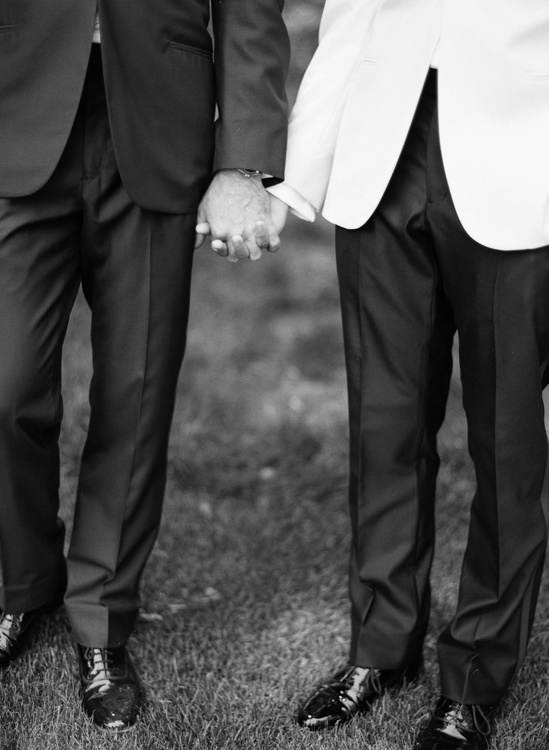 two grooms holding hands