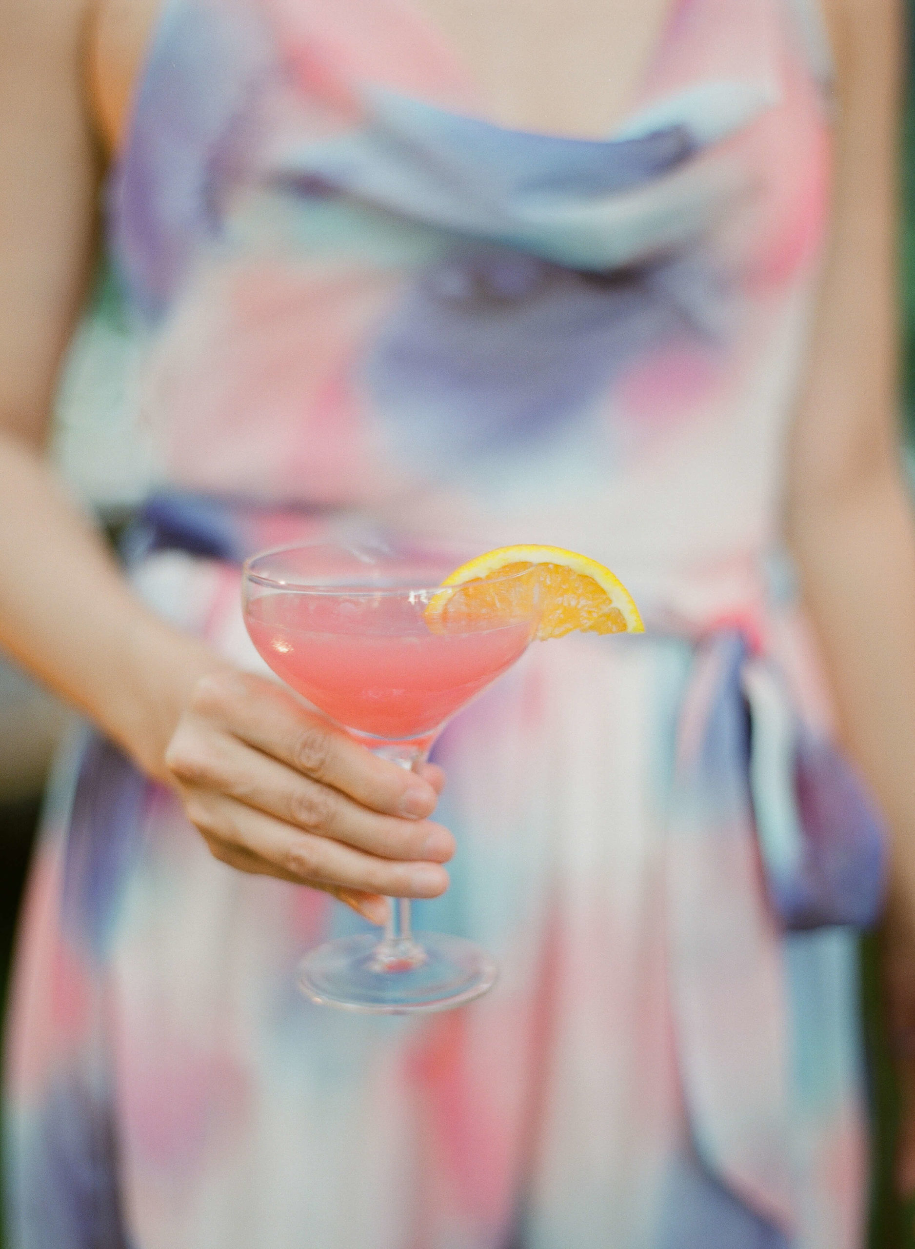 pink cocktail with lemon garnish