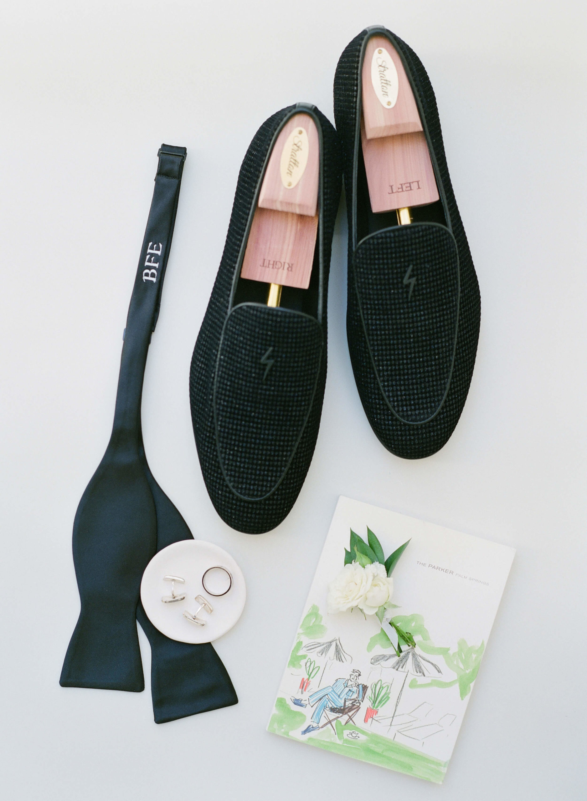 groom's black loafers and accessories