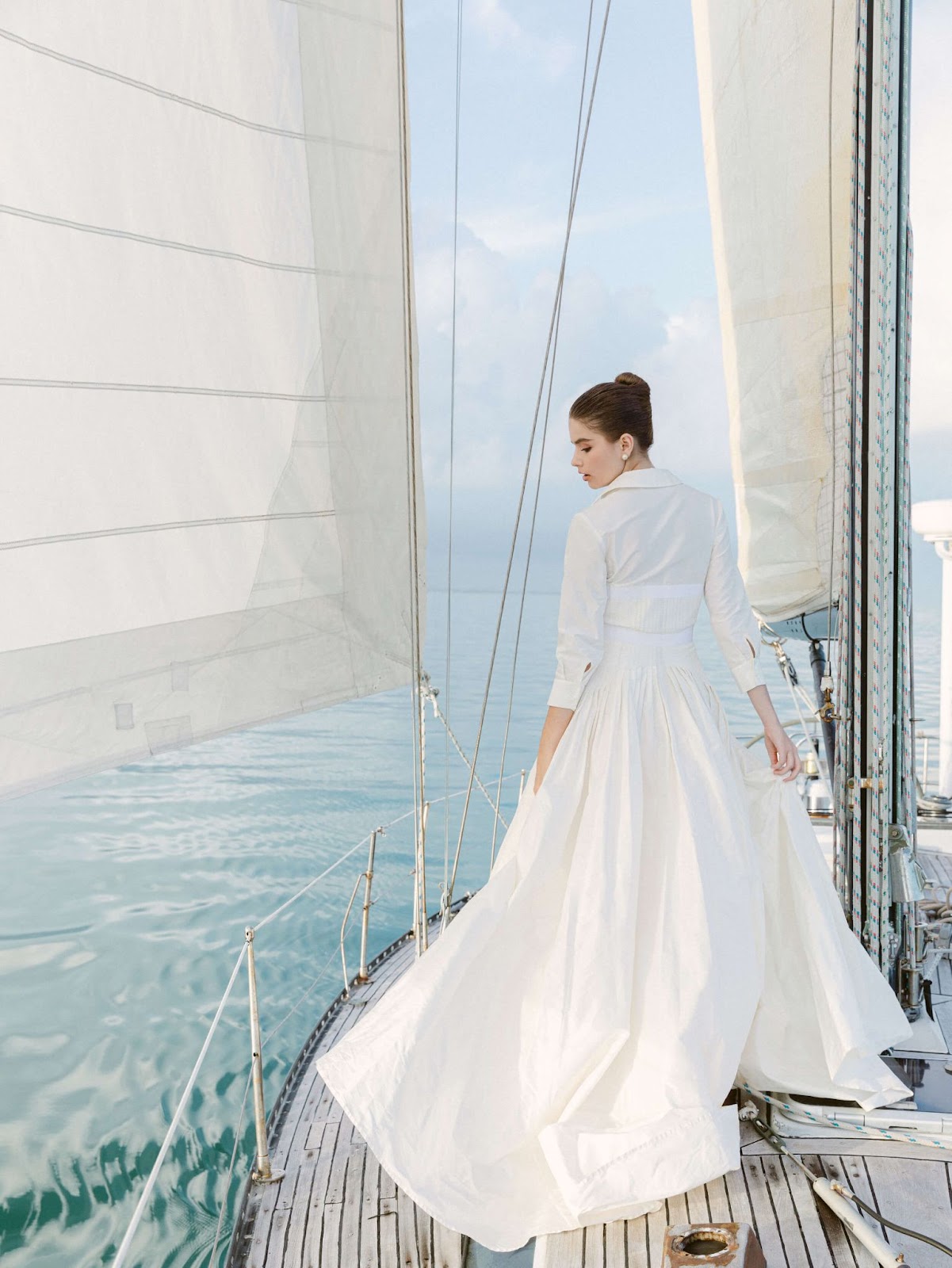 Carolina Herrera bridal gown worn on a sailboat editorial photo shoot