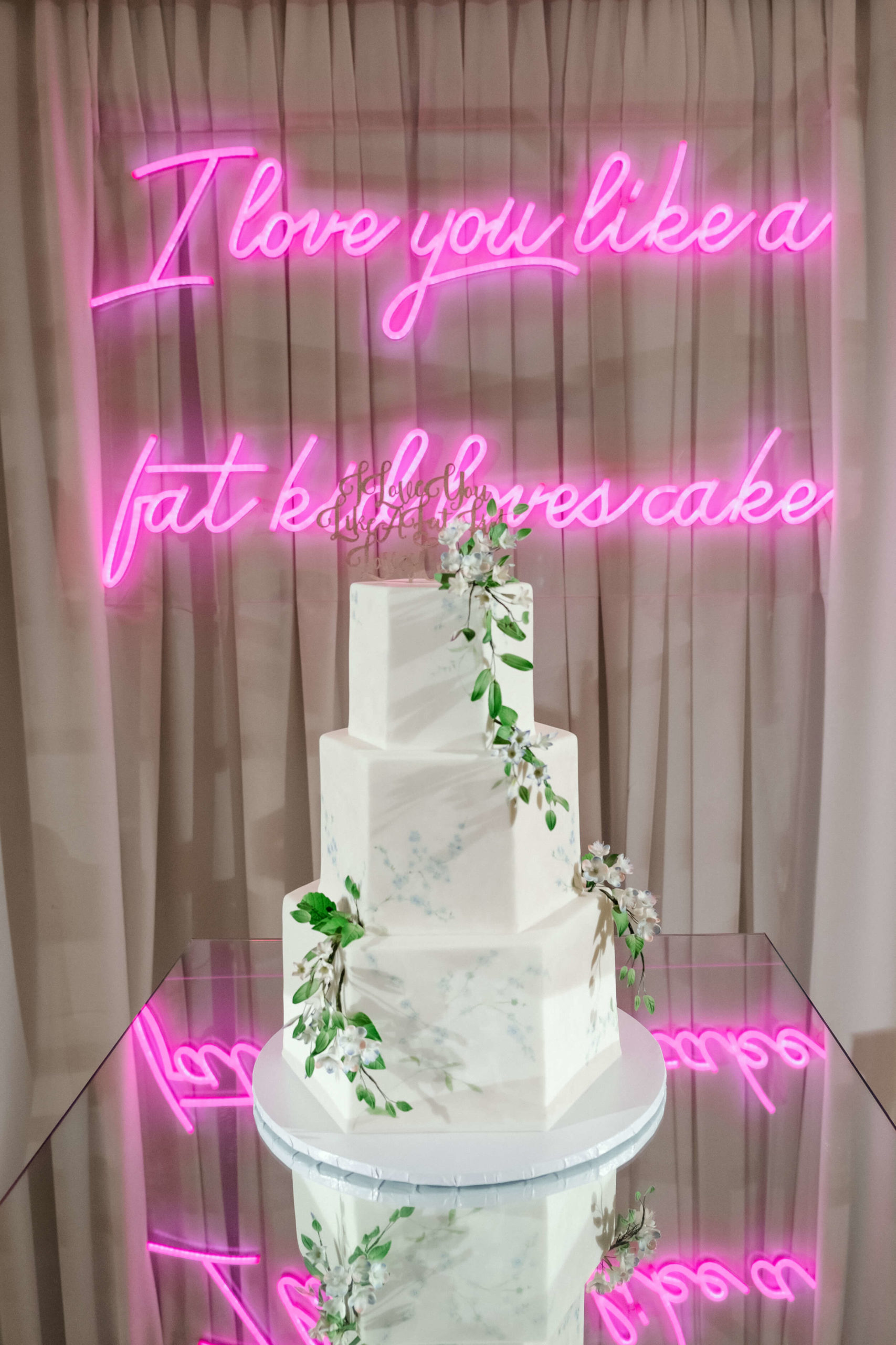 wedding cake and neon sign designed by top wedding planner Layne Povey