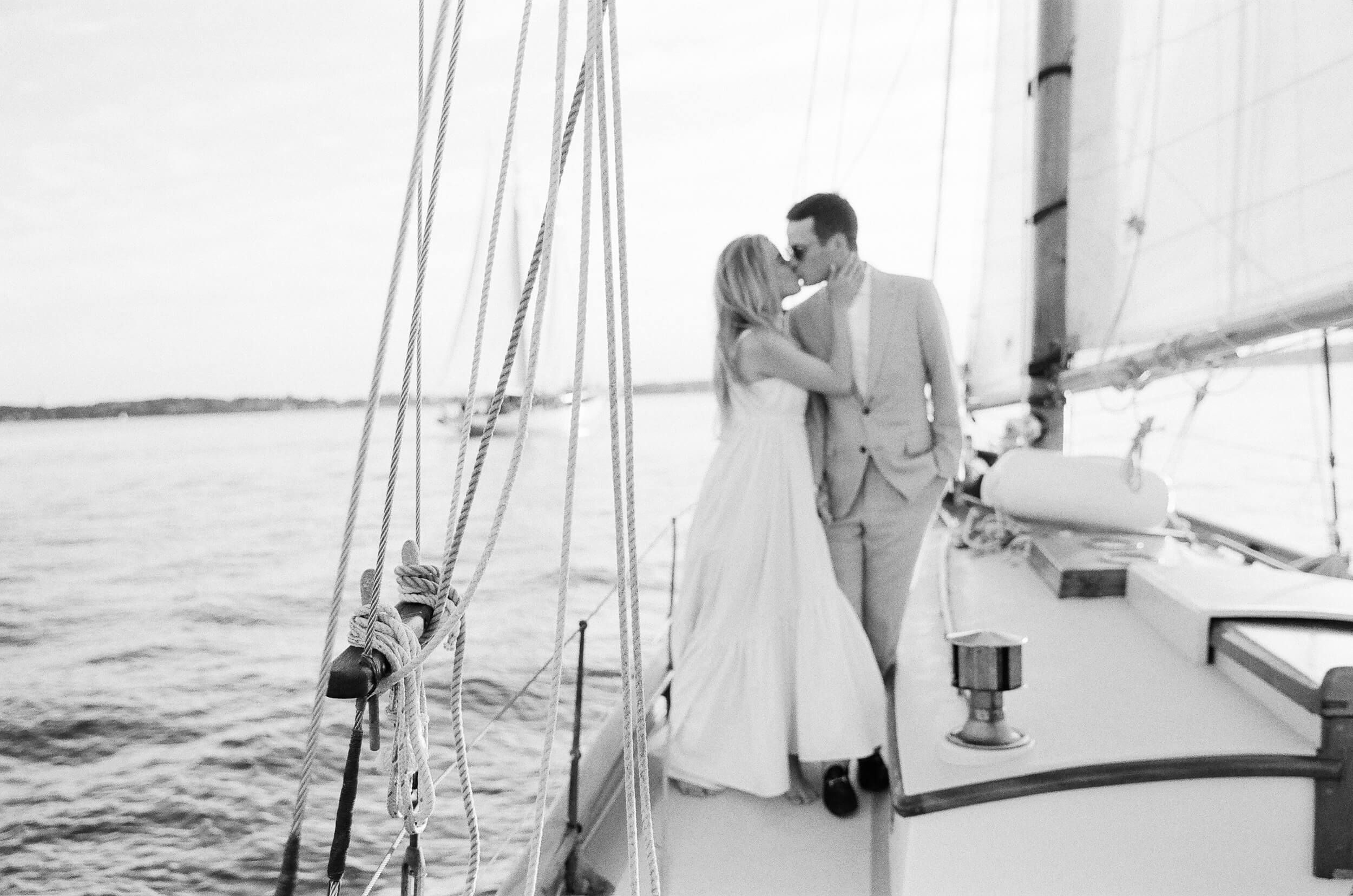 couple kissing on boat in Maine