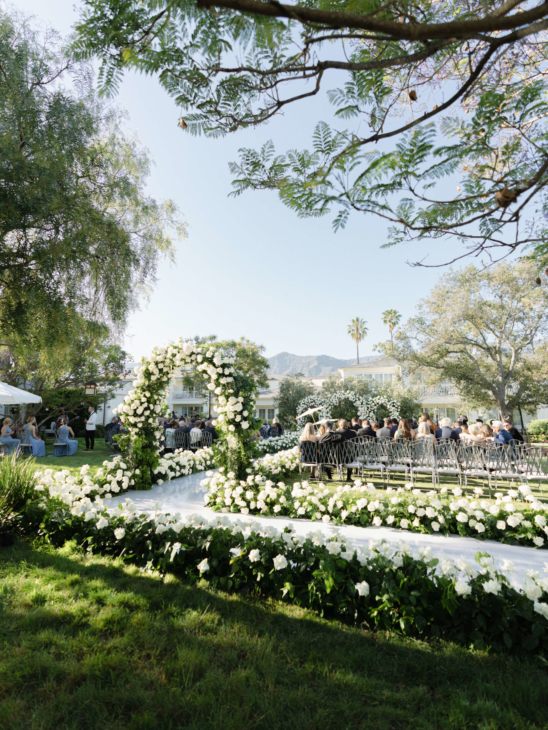 White flowers lining a wedding isle at Rosewood Miramar Beach in Montecito, a coastal town in Santa Barbara County, California