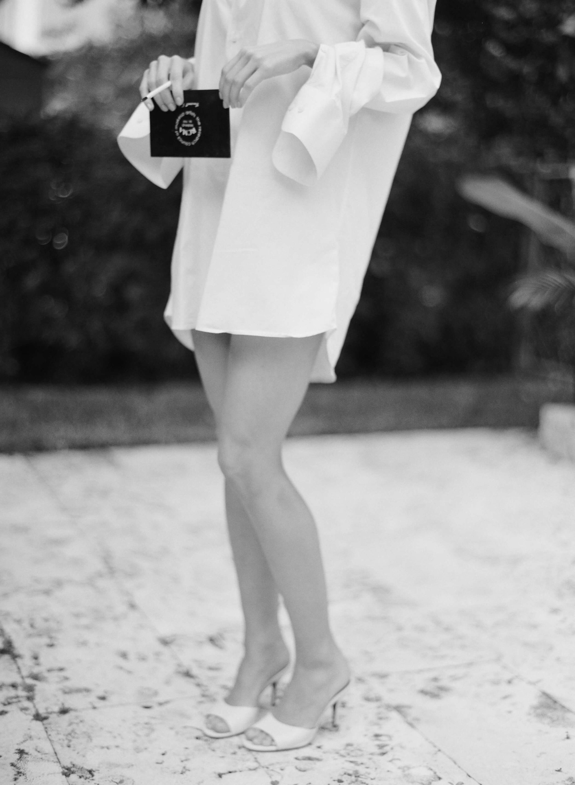 Artistic fashion photo; bride wearing men's oversized shirt with heels