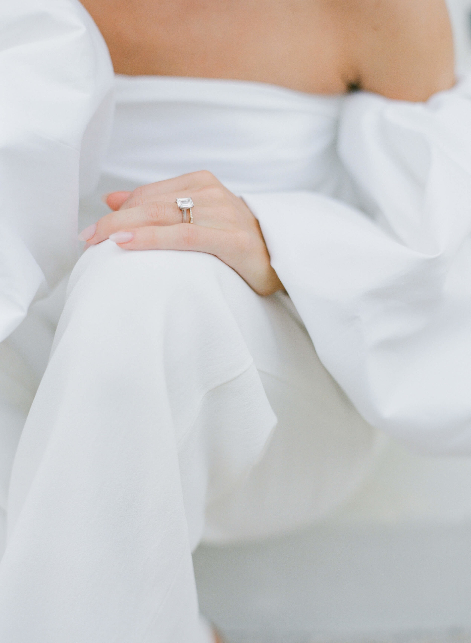 Closeup image of Bride's ring and outfit