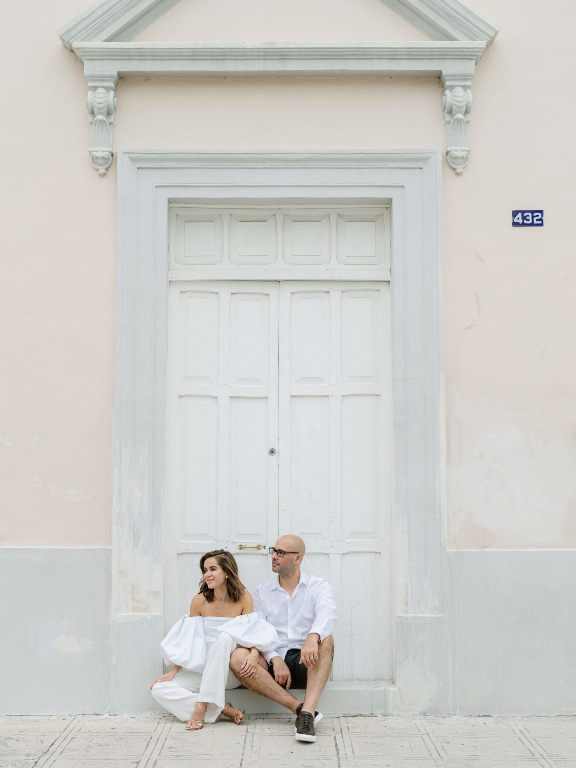 Bride and groom sitting outside an old building