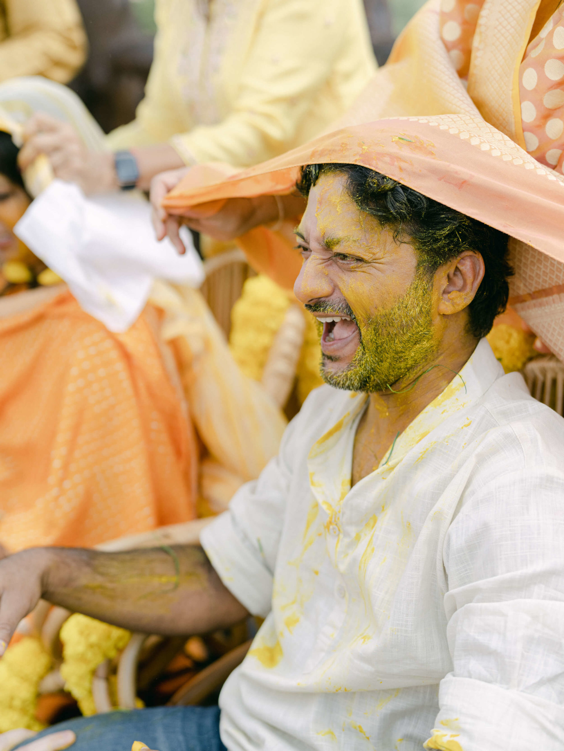 Ari covered in turmeric paste at Haldi ceremony: an Indian wedding tradition