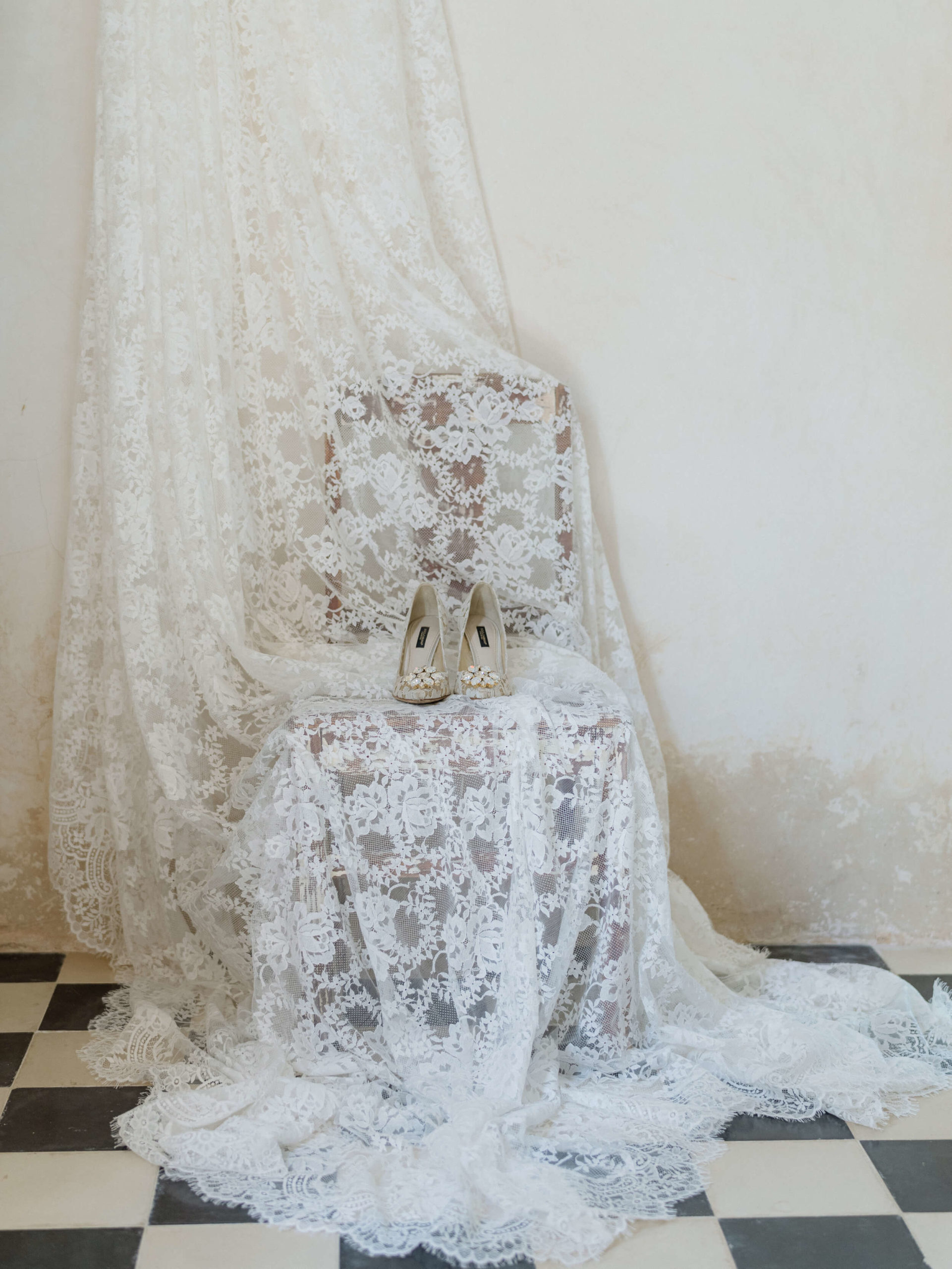 Bride's shoes on a chair draped in lace