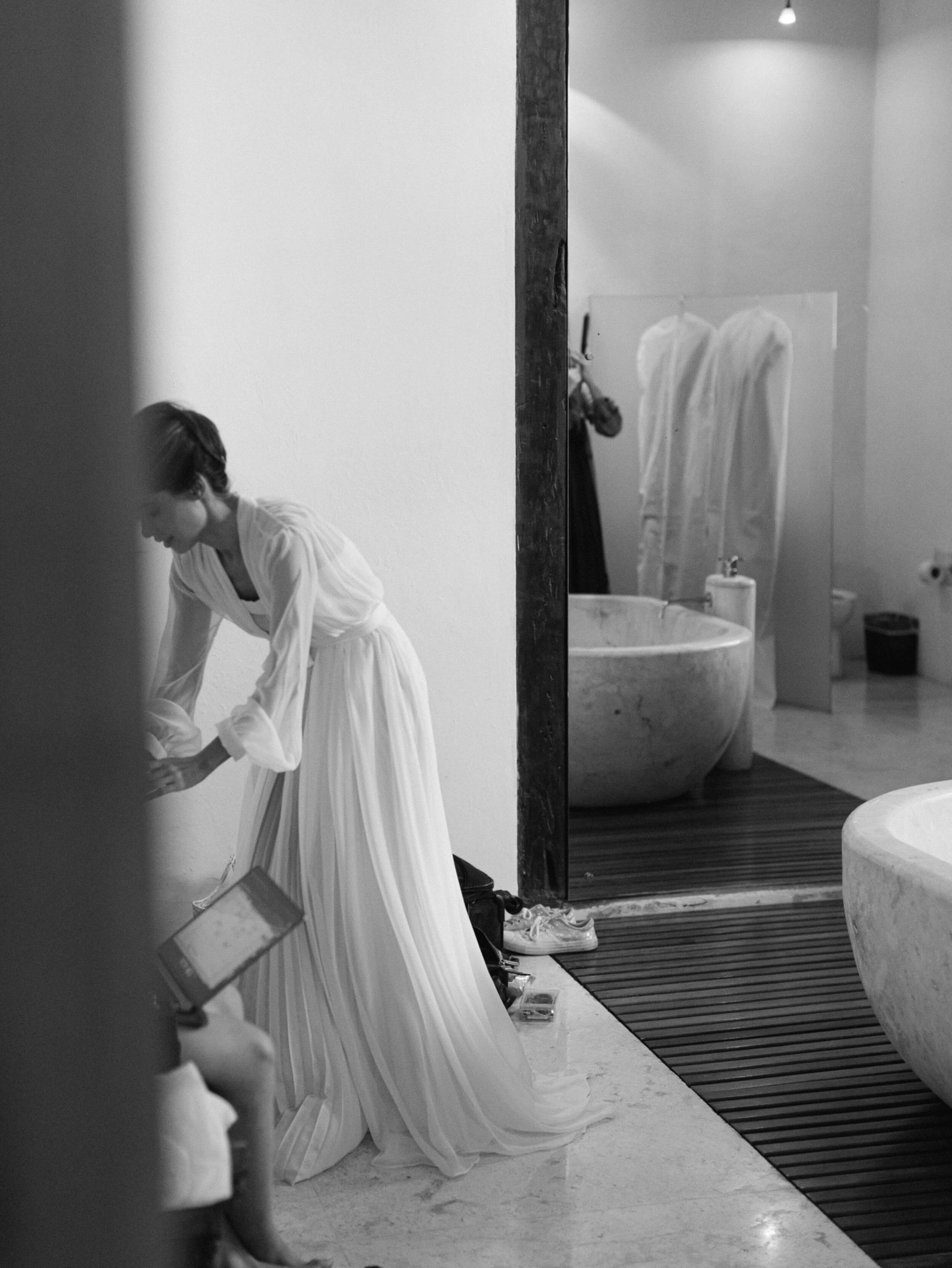 Bride getting ready in flowing dressing gown