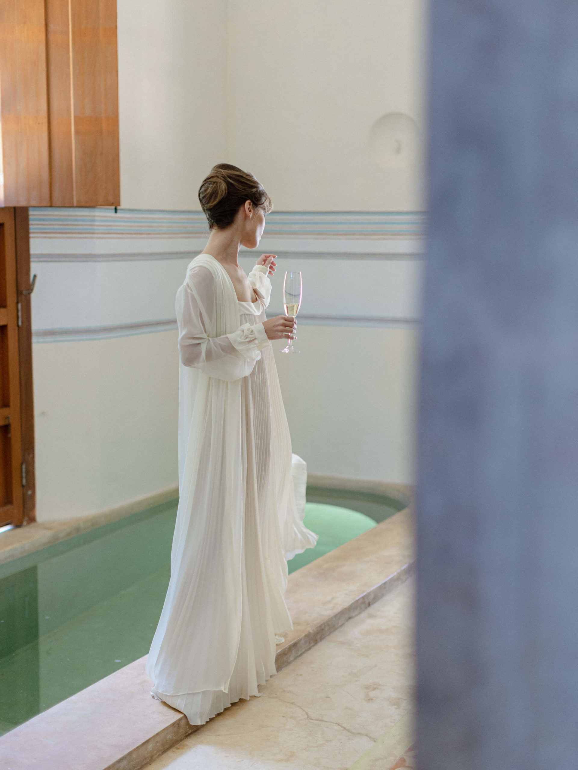 Bride holding champagne in her dressing gown