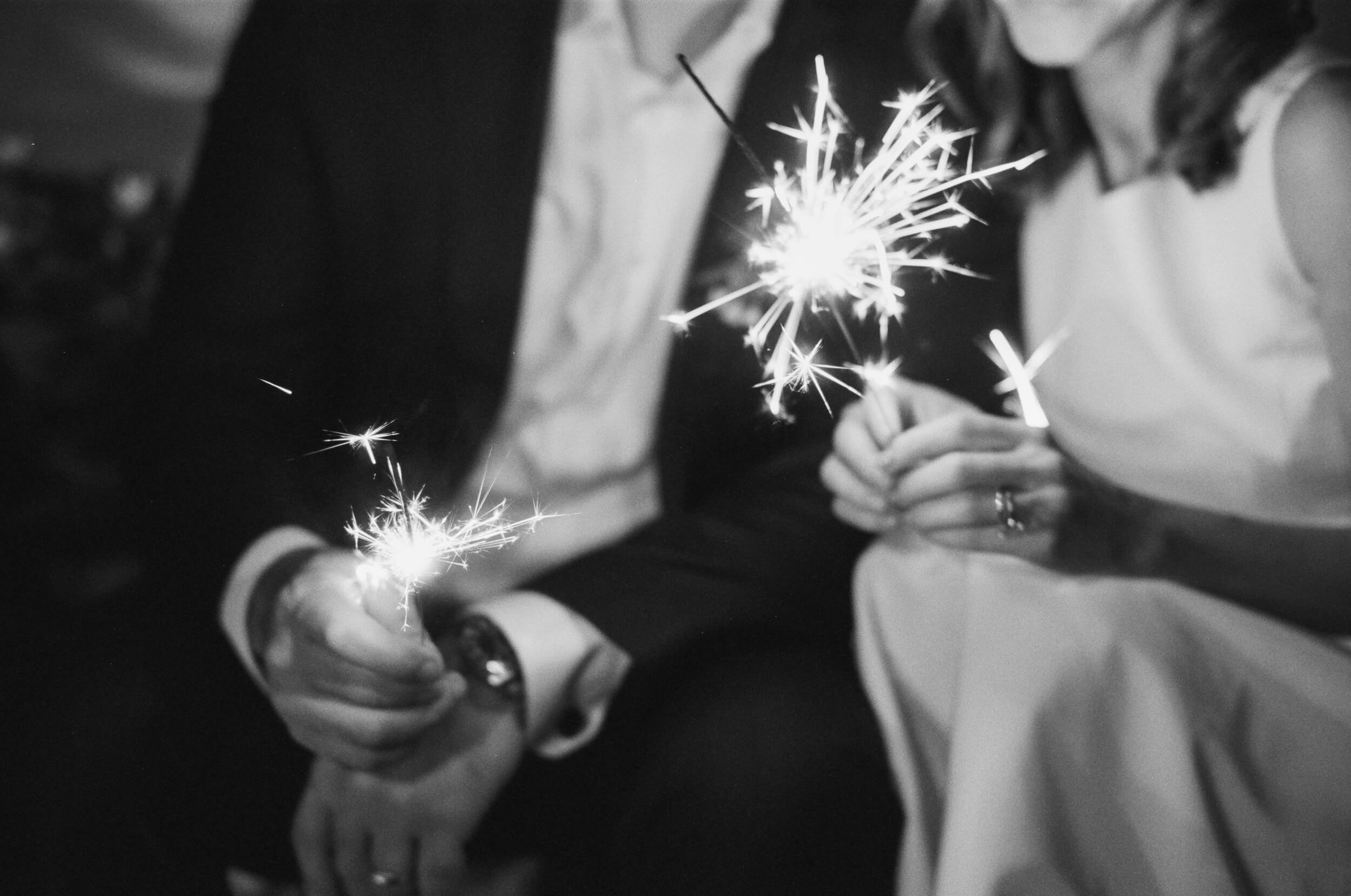 Bride and groom holding sparklers in celebration of their Miami wedding.