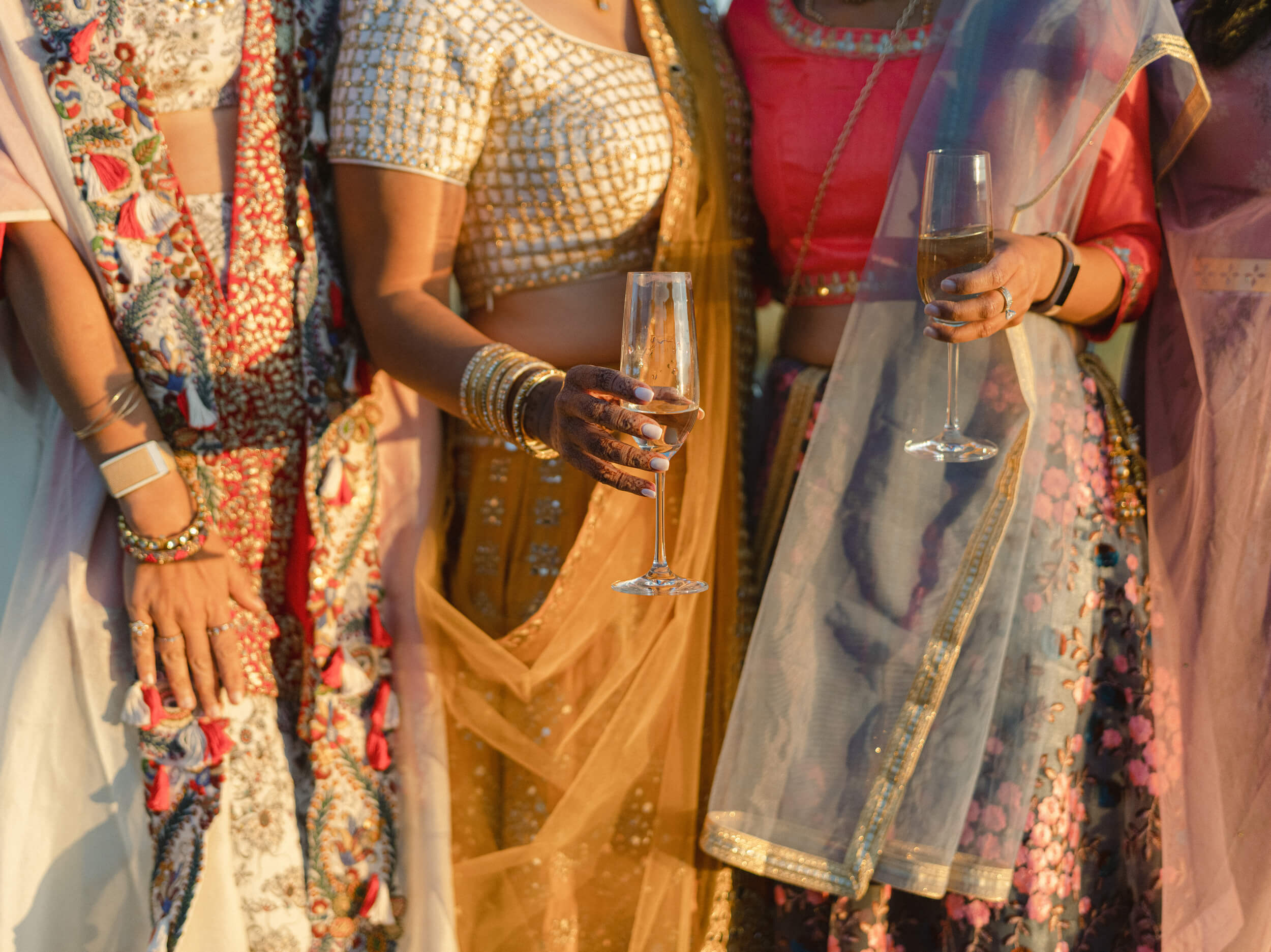 Women in saris holding champagne