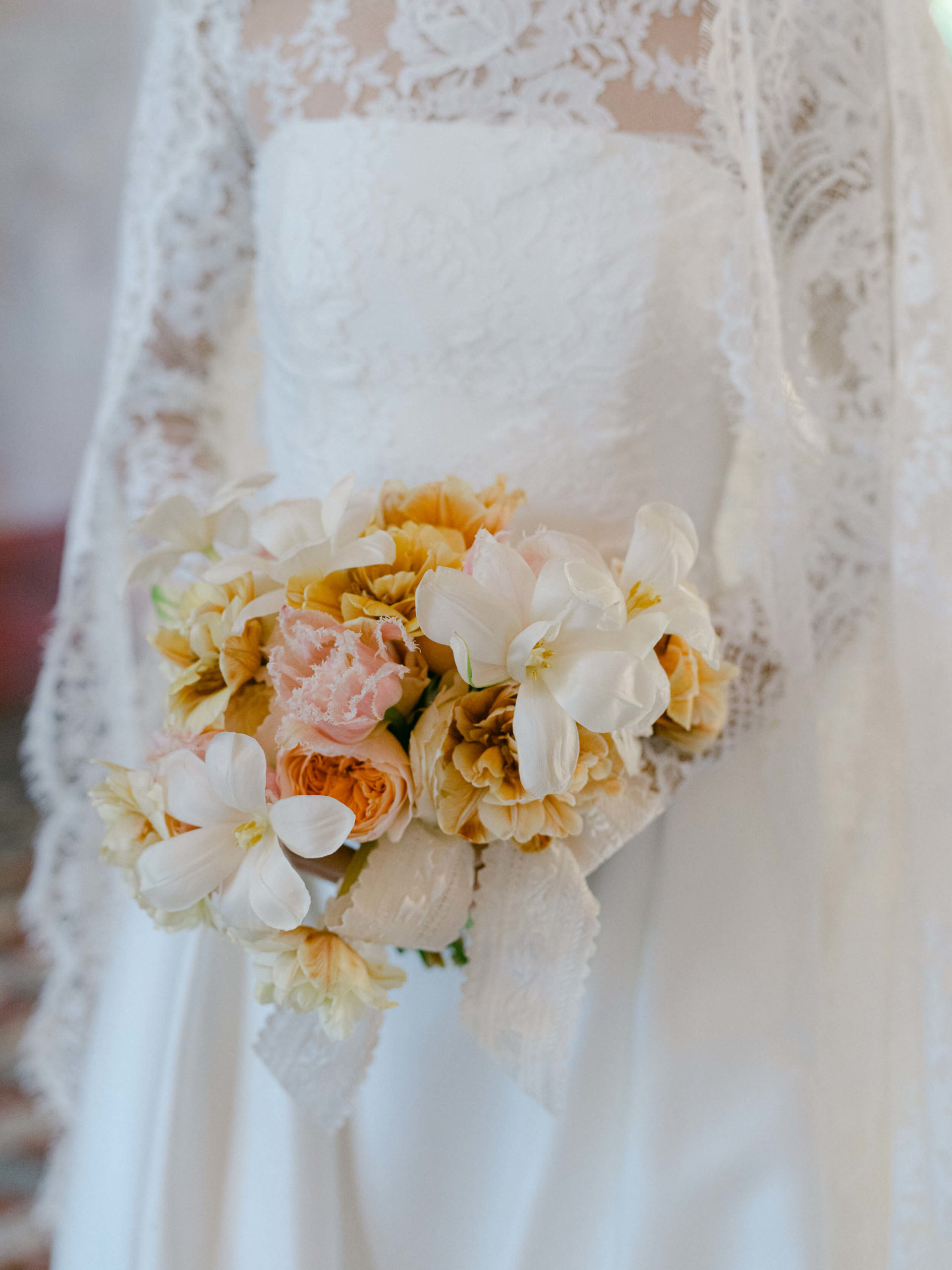 Bride holding bouquet in her wedding dress