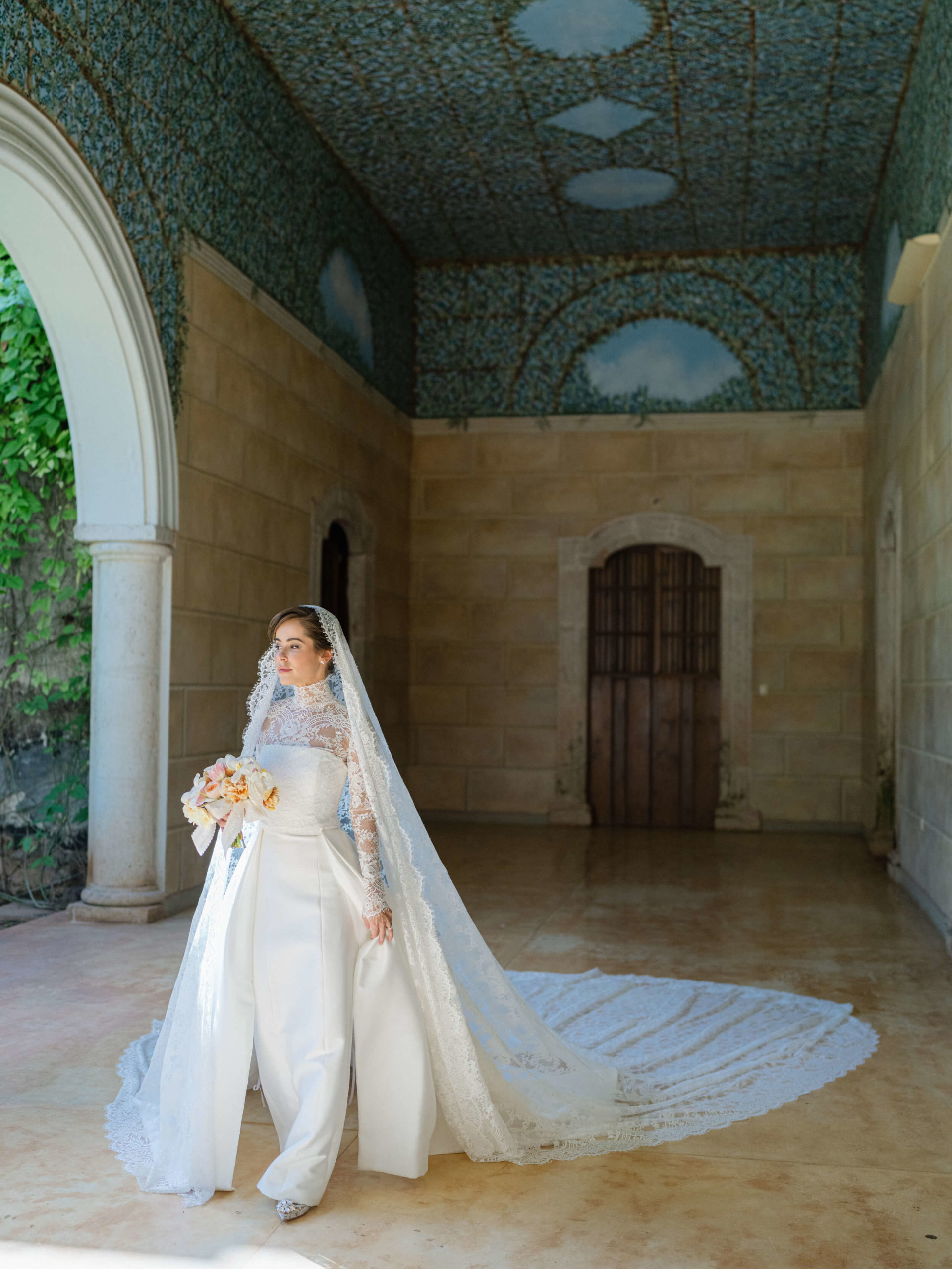 Bride in wedding dress and veil, holding bouquet