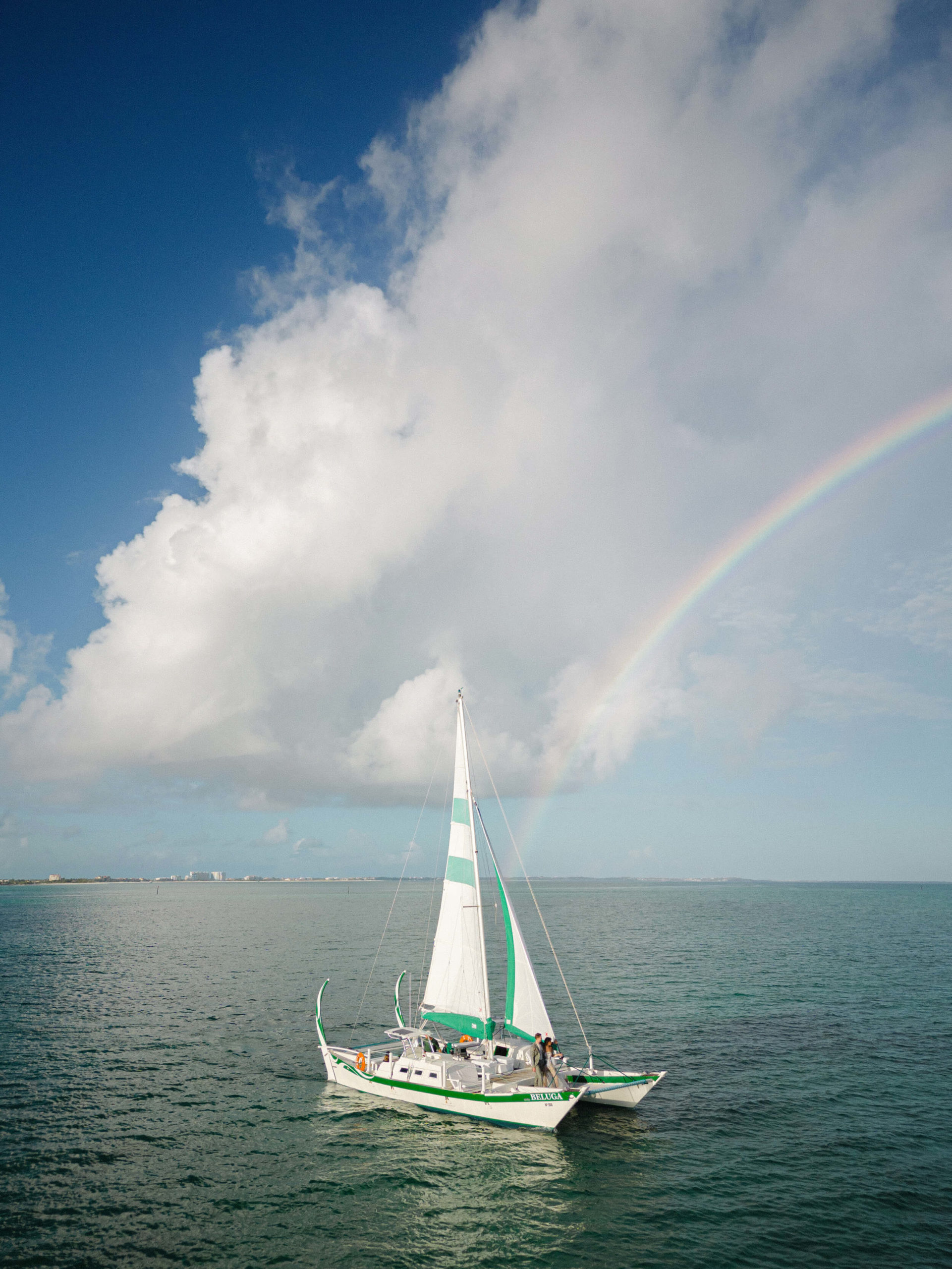 A rainbow over a boat on the water
