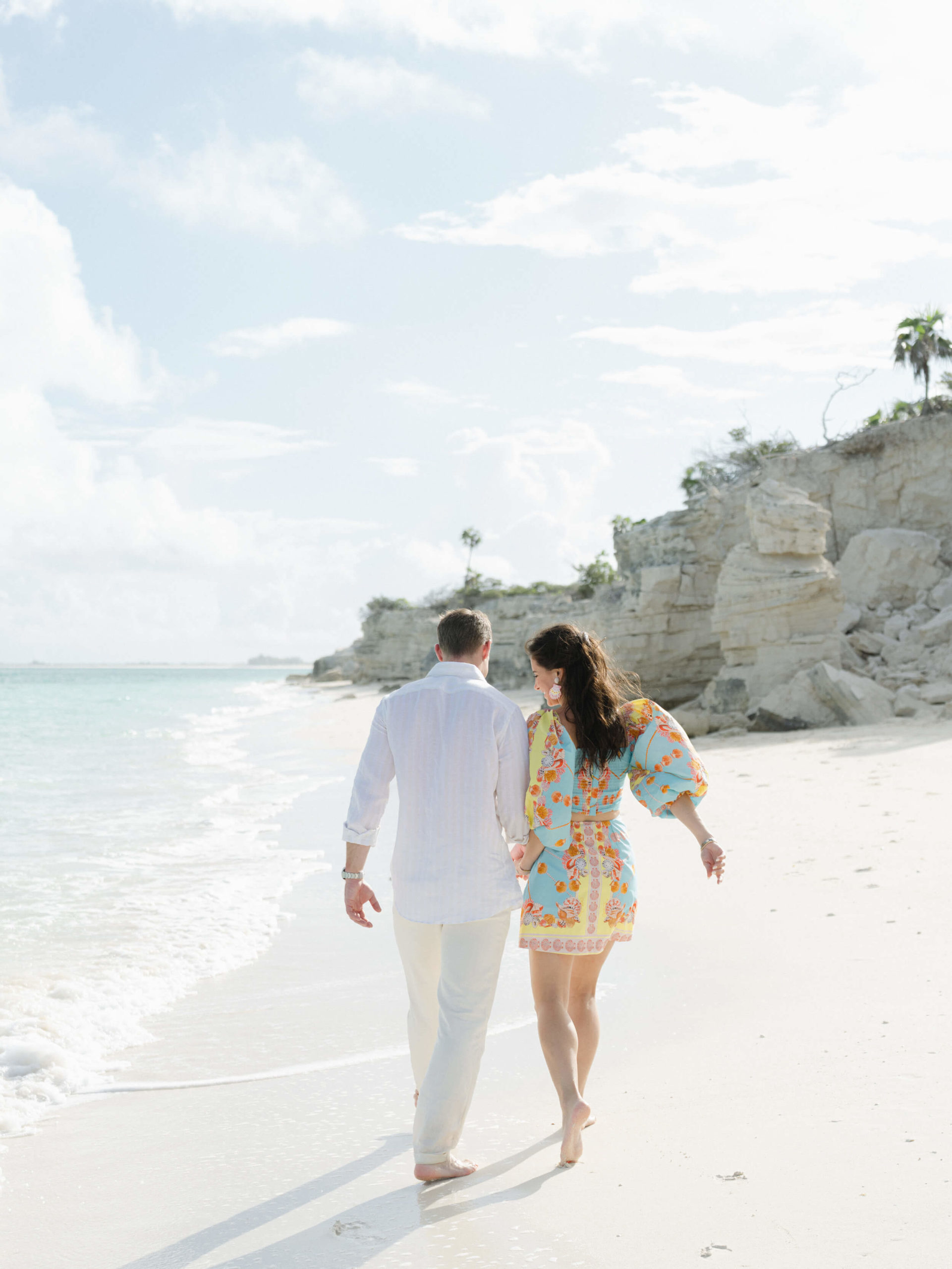 Liz and Dave walking along the rocky coast in Turks and Caicos
