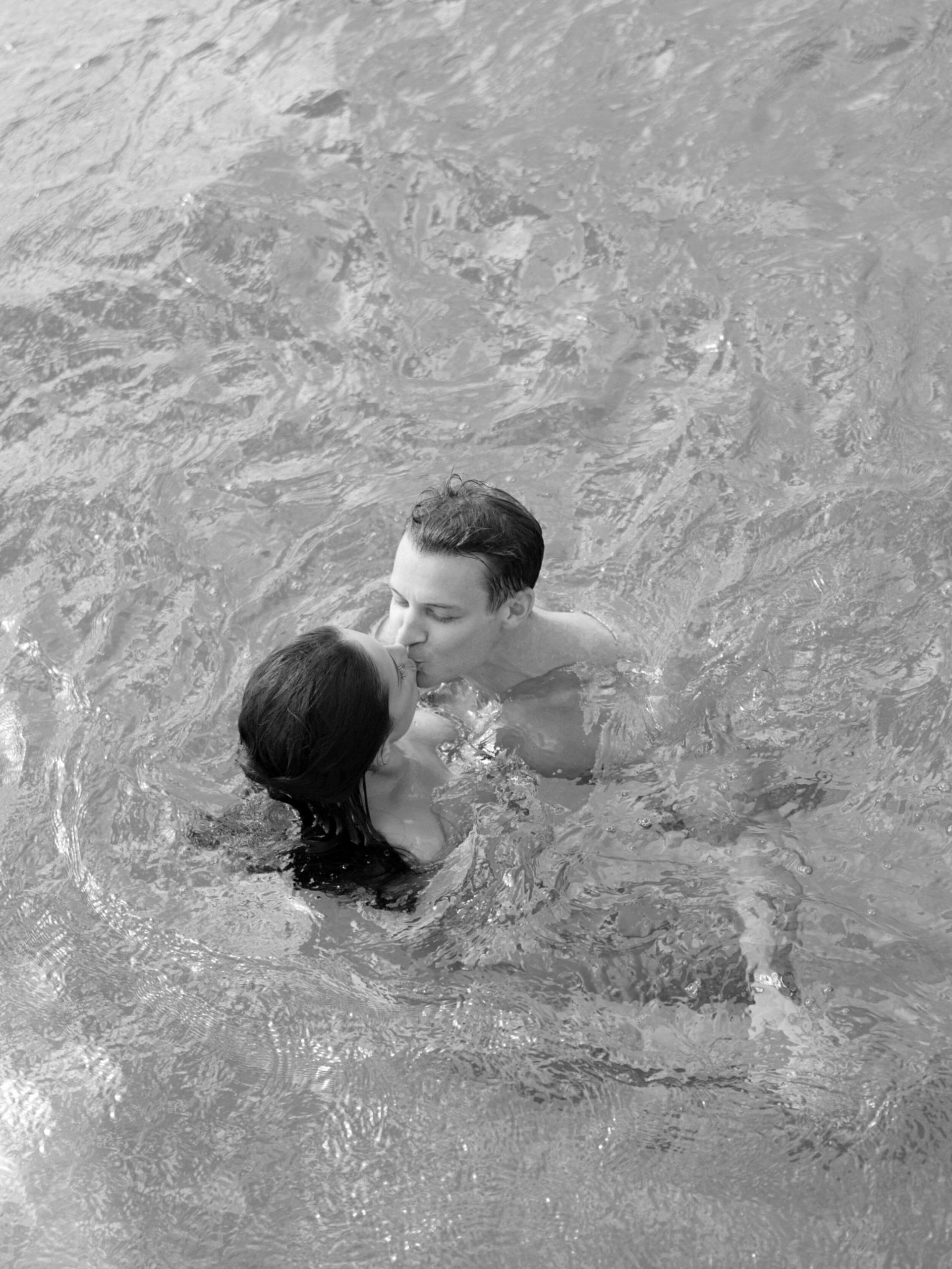 Liz and Dave kissing in the water