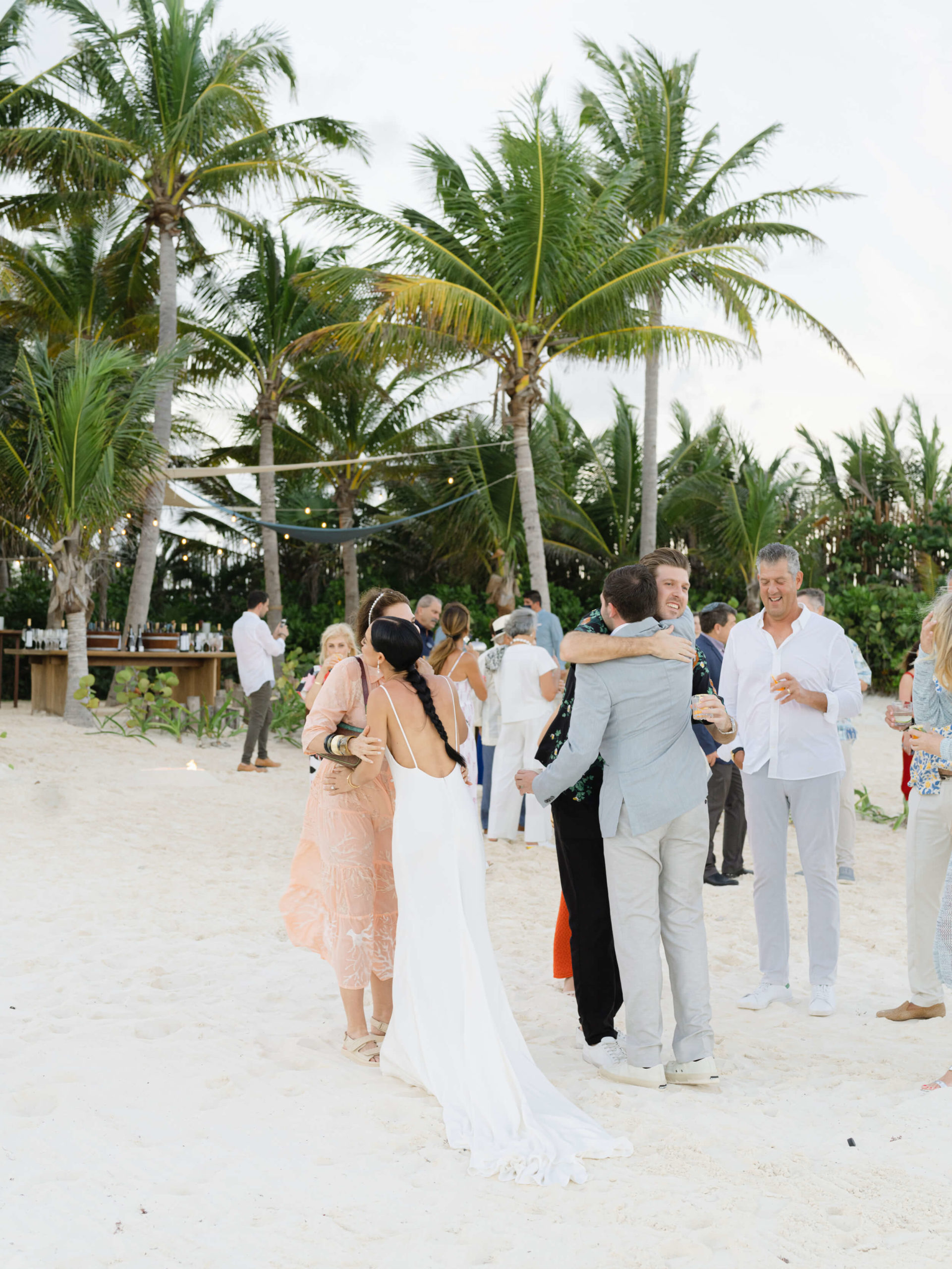 Danielle and Lucas embracing their friends and family at their Rosewood Mayakoba wedding