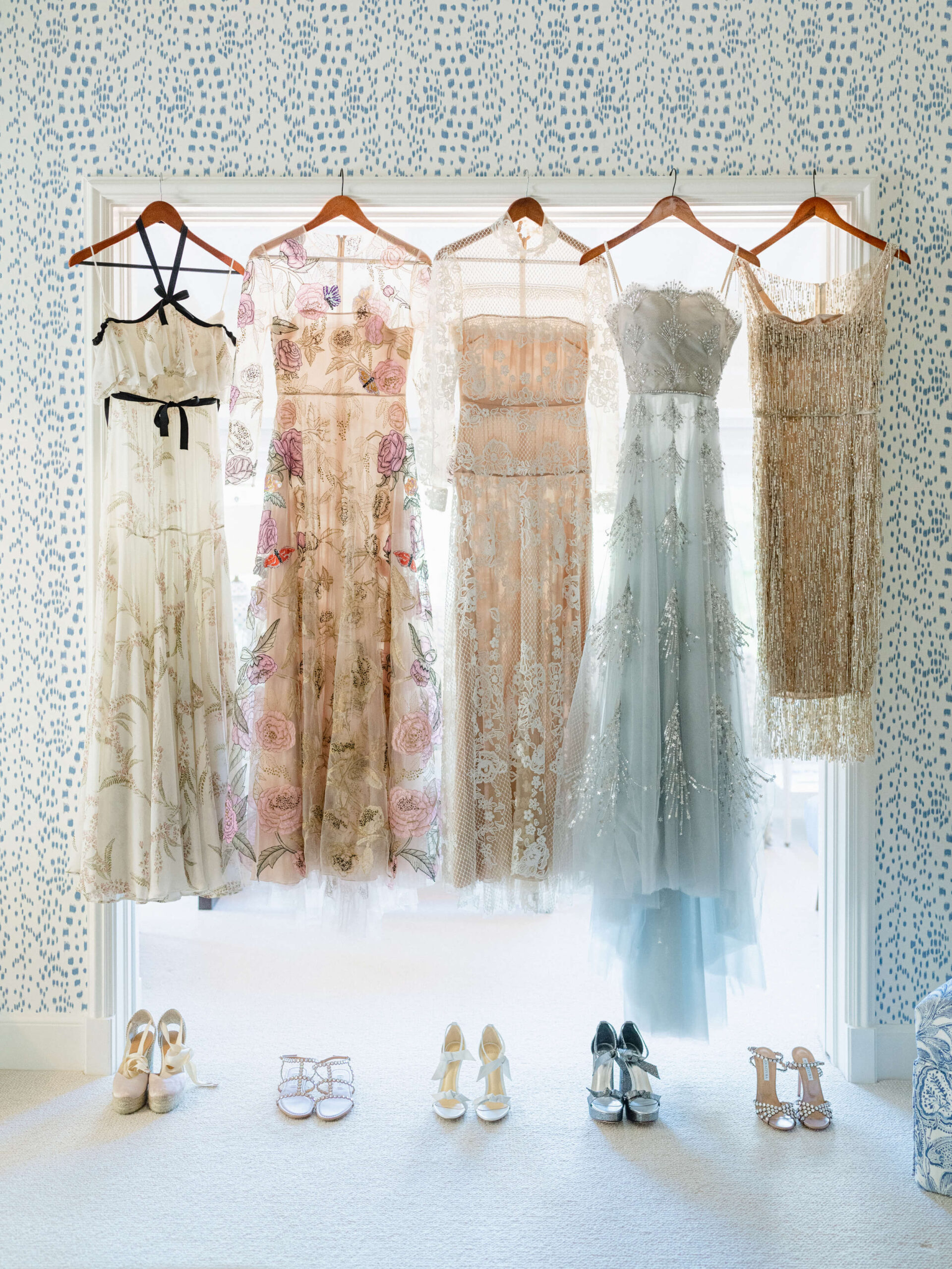 Dresses hung up against a bright window