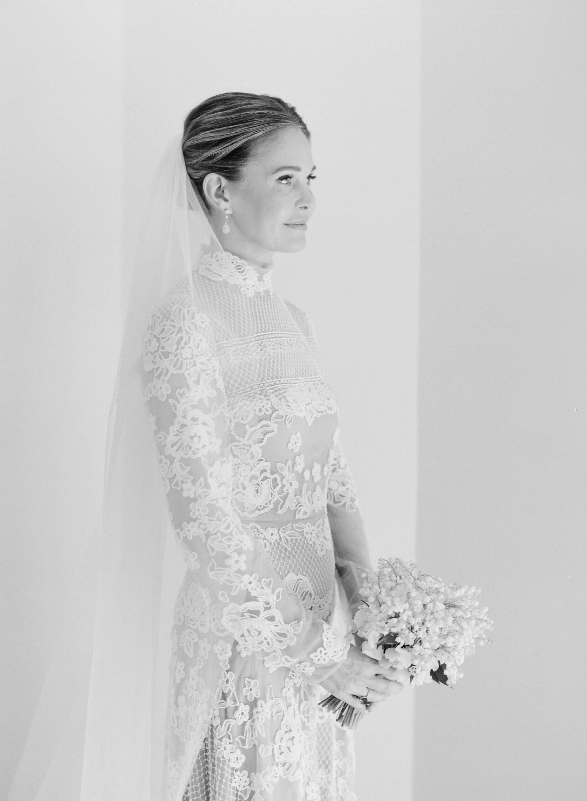 Abigail in her wedding dress, holding her bouquet