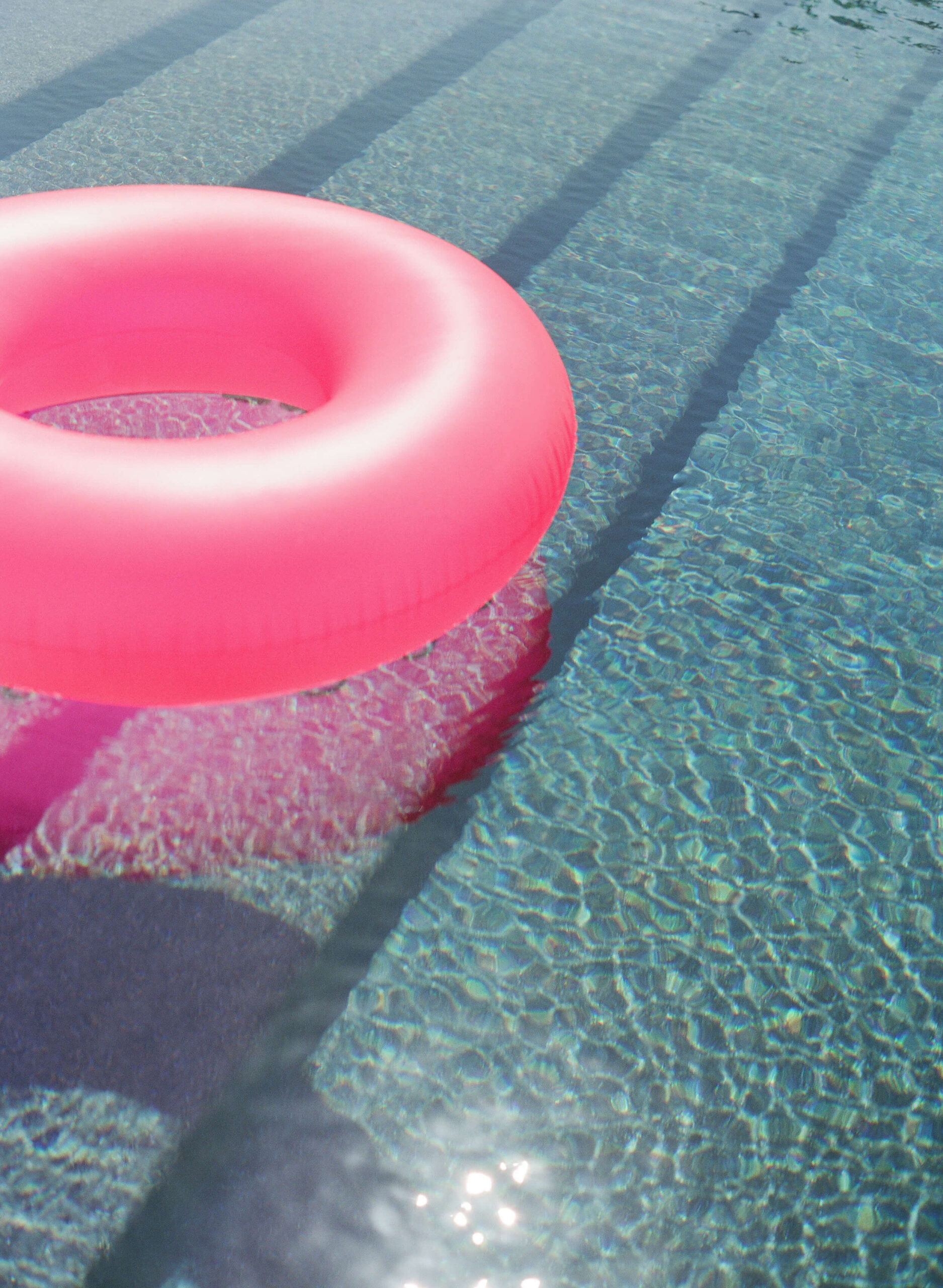 Pink inner tube floating on the water