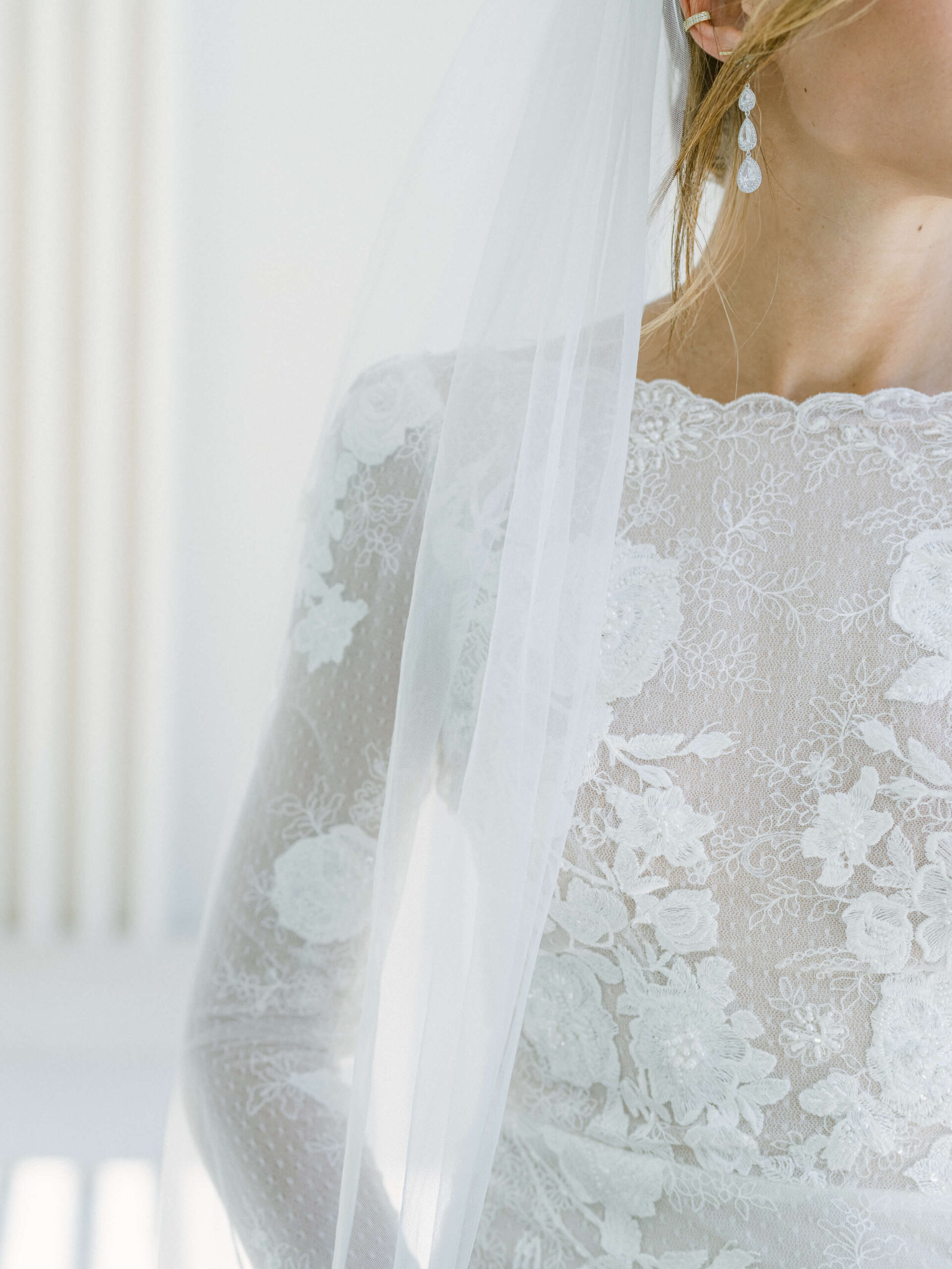 Closeup of Olga's wedding dress and earrings