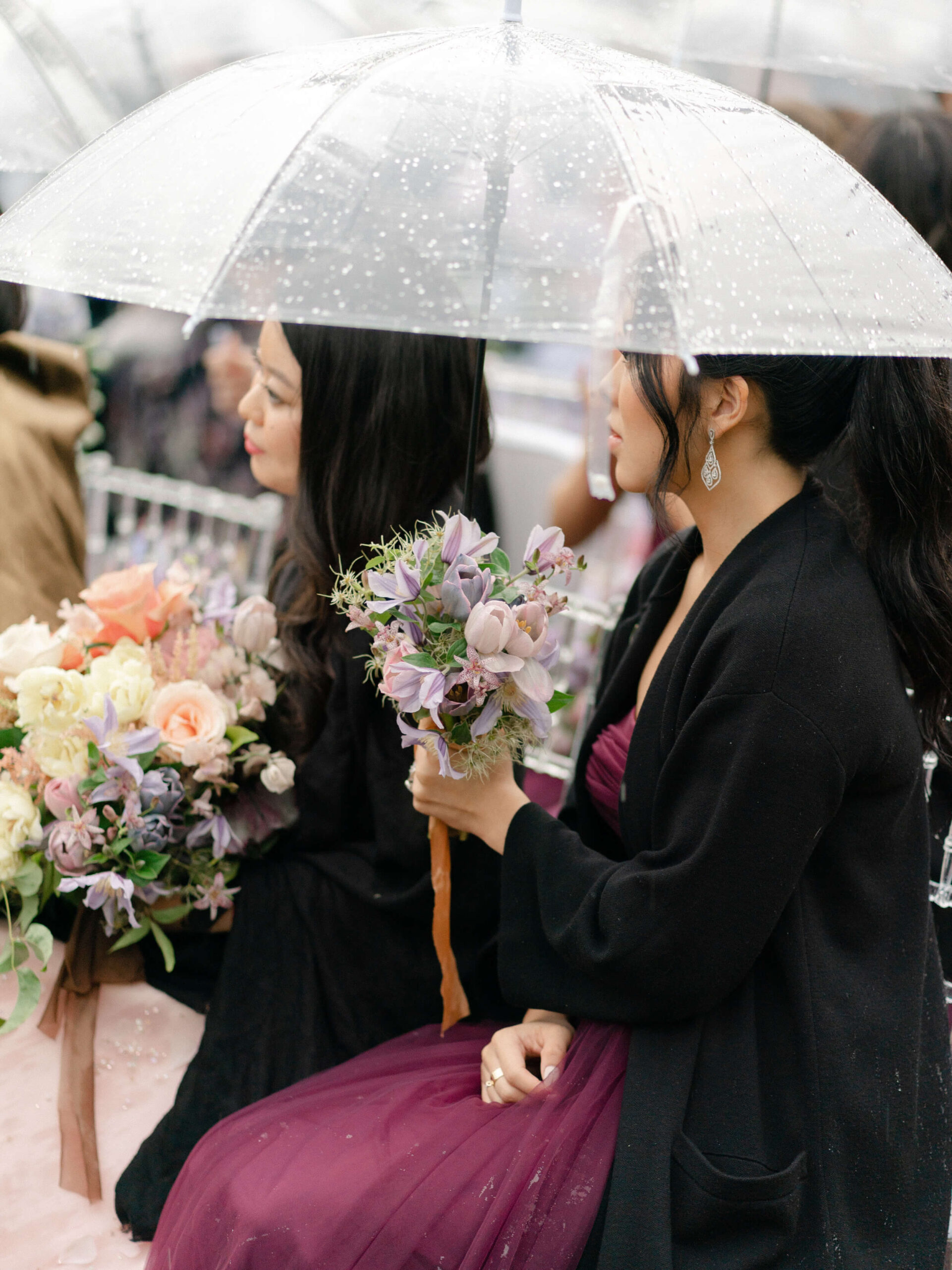 transparent umbrellas cover the bridesmaids from an unexpected shower