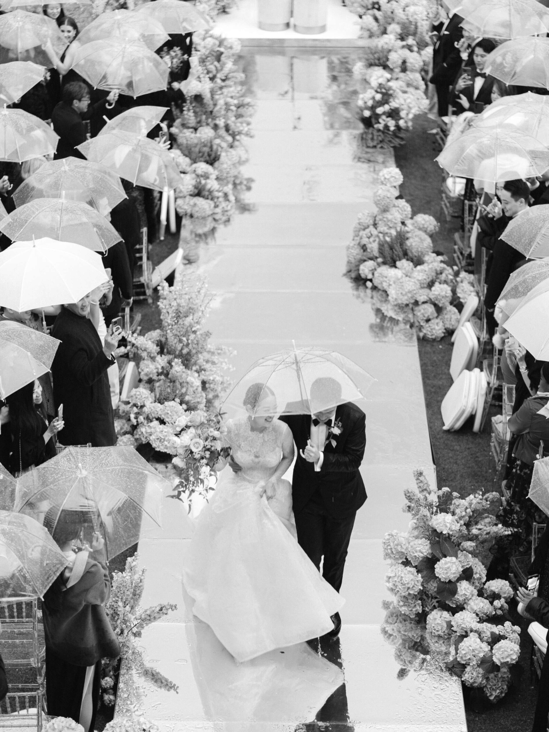 black and white shot of bride and groom walking down the isle at the end of the ceremony